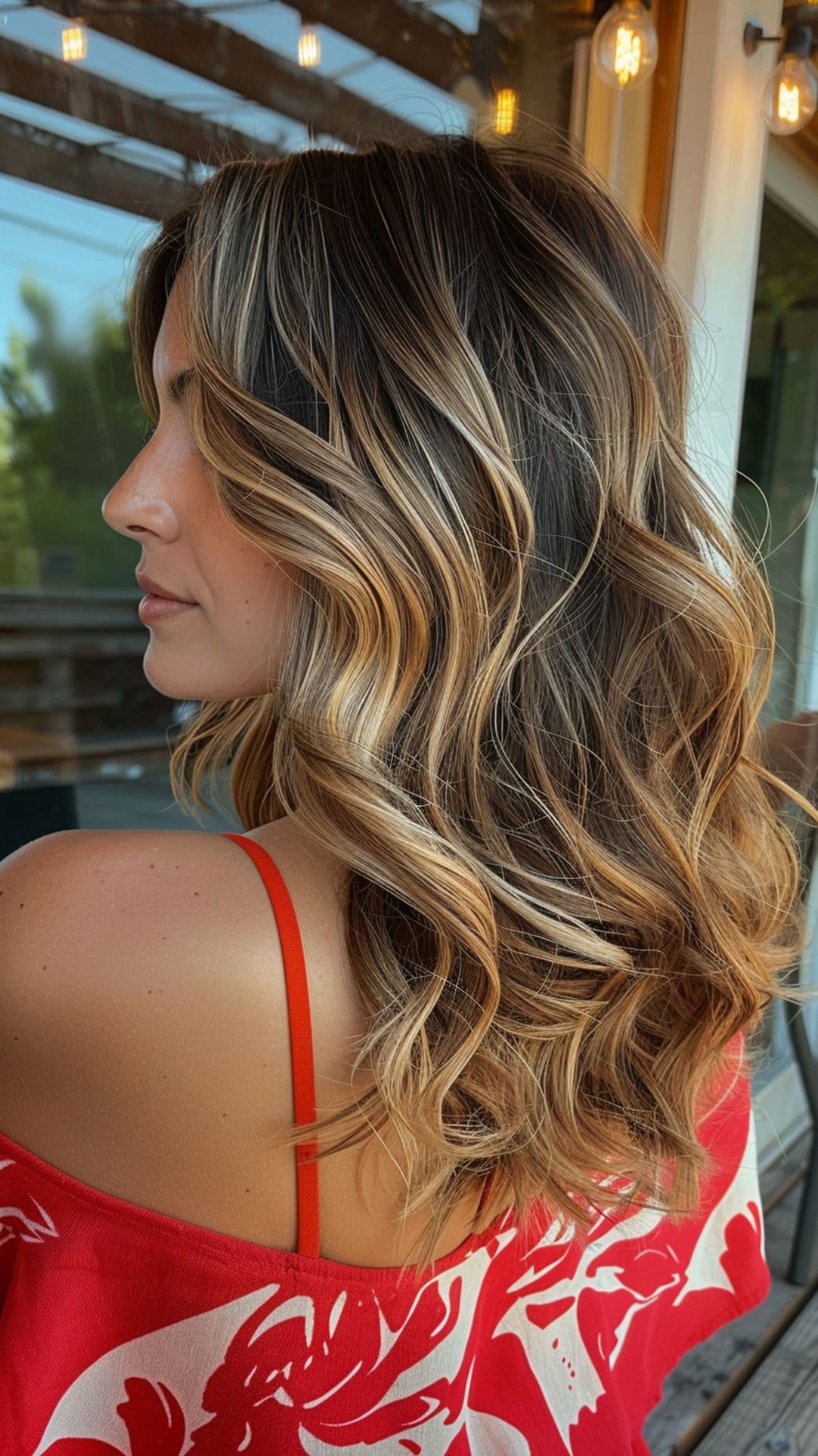 A woman modelling a bronze balayage hair.