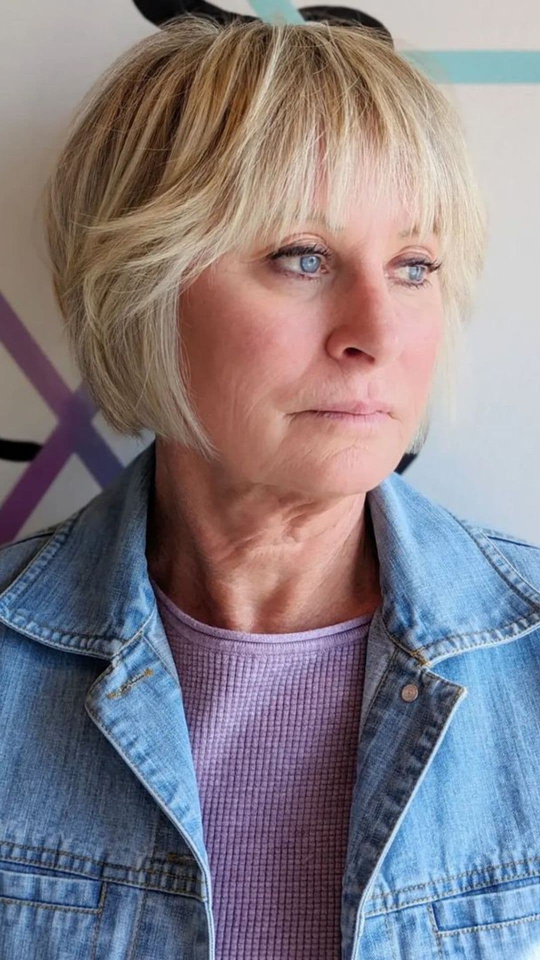 An older woman modelling a shaggy bob haircut.