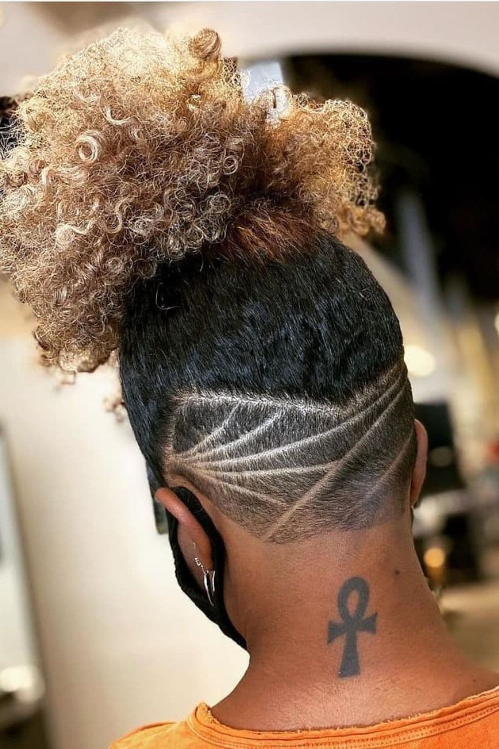 A black woman with an undercut.