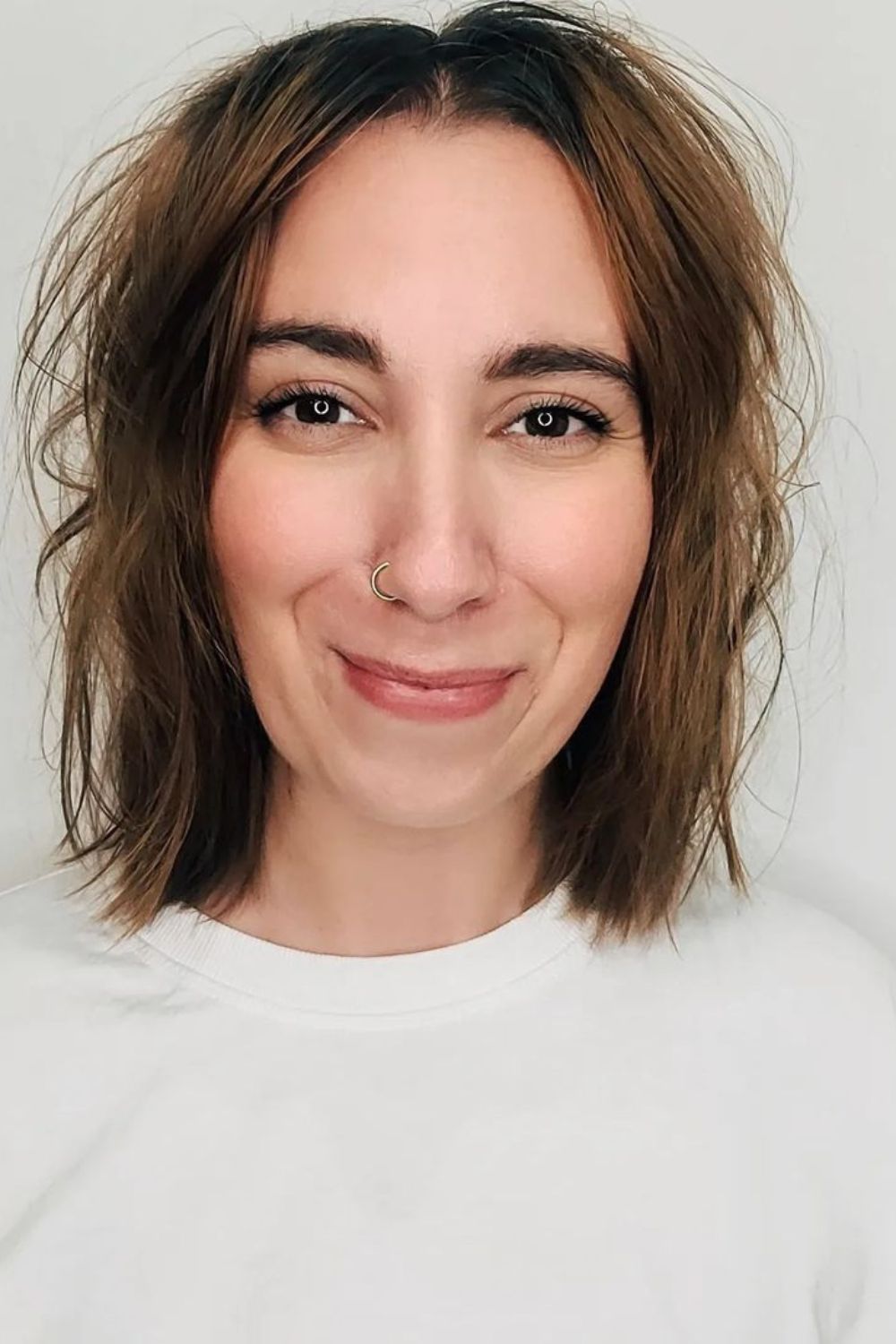 A woman with a brown messy lob.