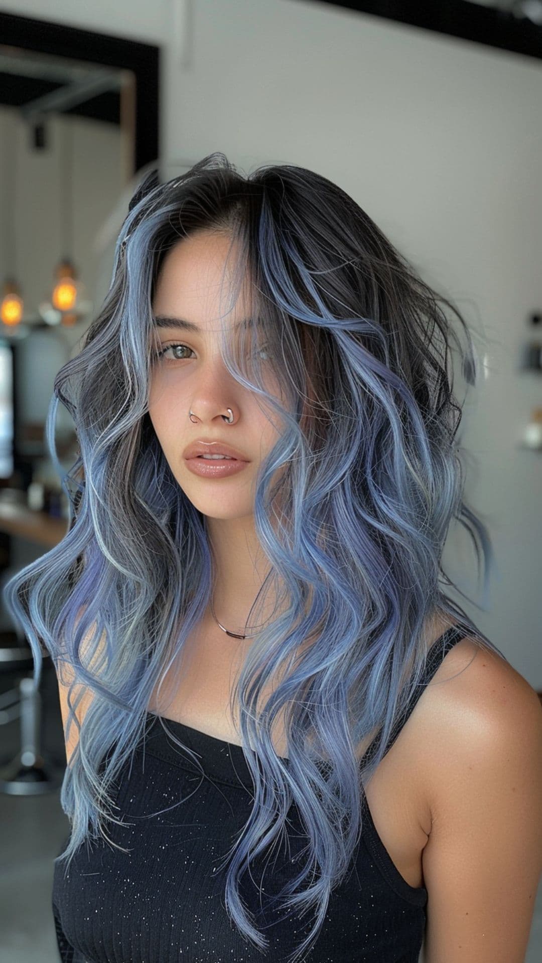 A woman modelling an ash blue chunky highlights hair.