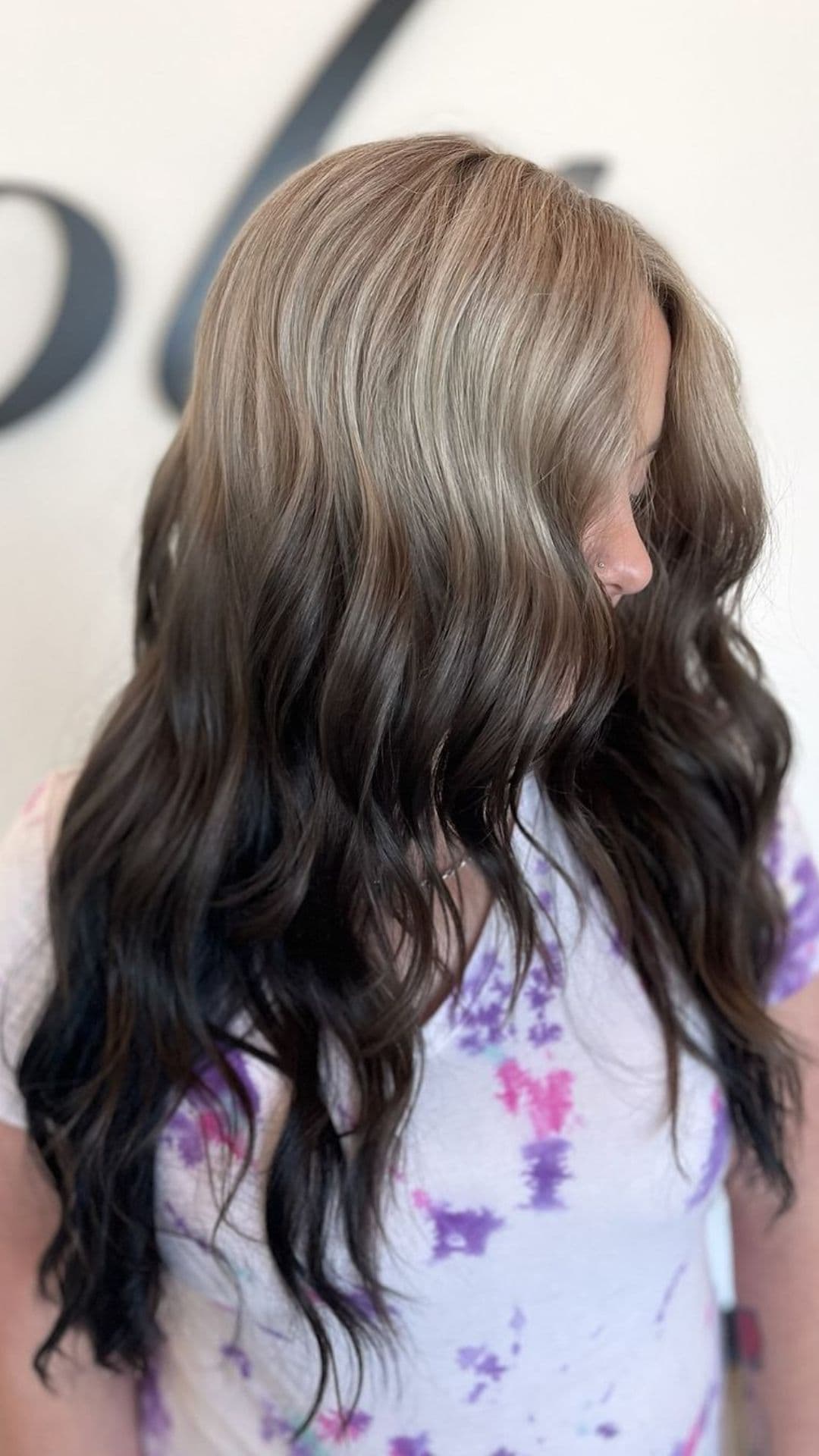 A woman modelling an ash gray to black reverse ombre.