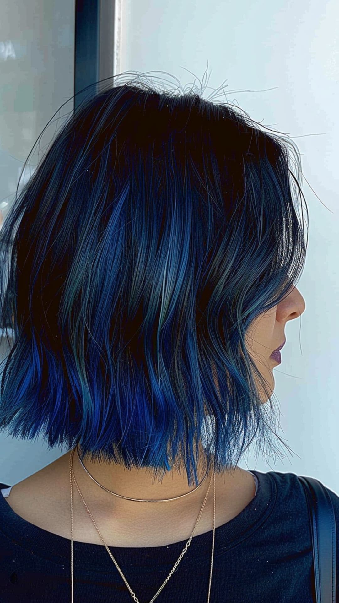 A woman modelling a black to blue ombre hair.