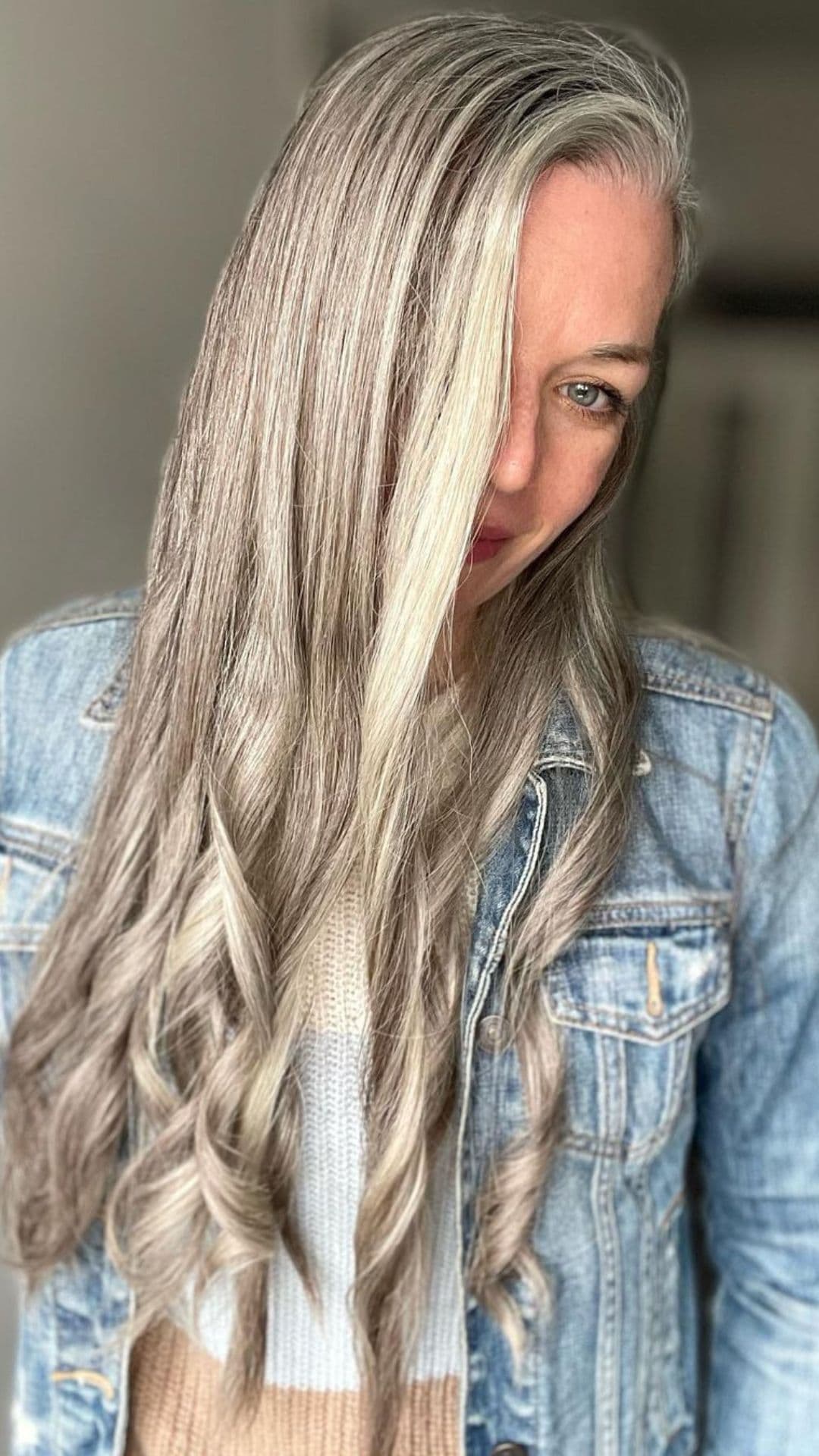 A woman modelling a blended silver and blonde hairstyle.