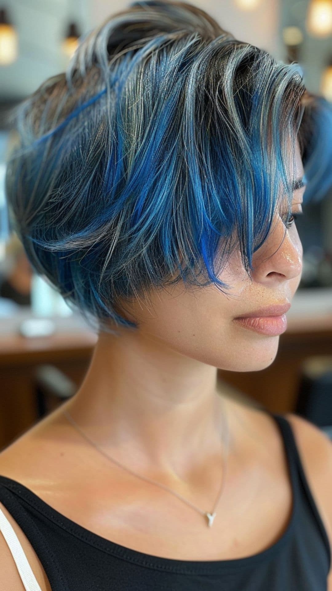 A woman modelling a blue balayage bixie cut.