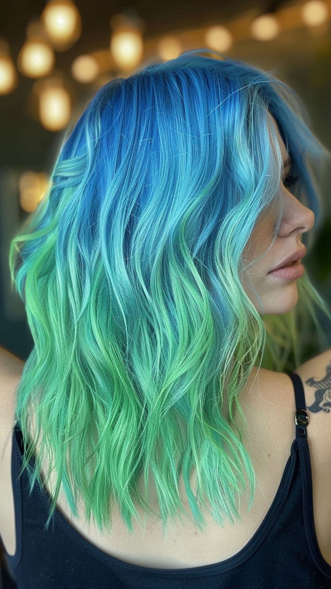 A woman modelling a blue to green hair.