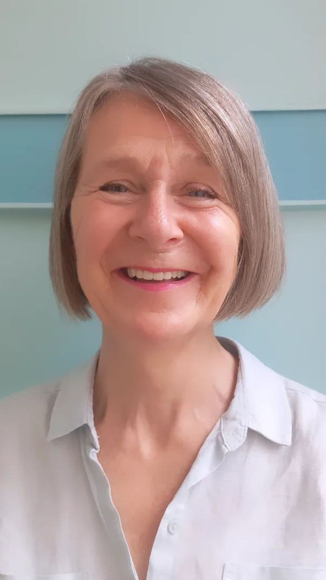 An older woman modelling a bob cut with deep side part.