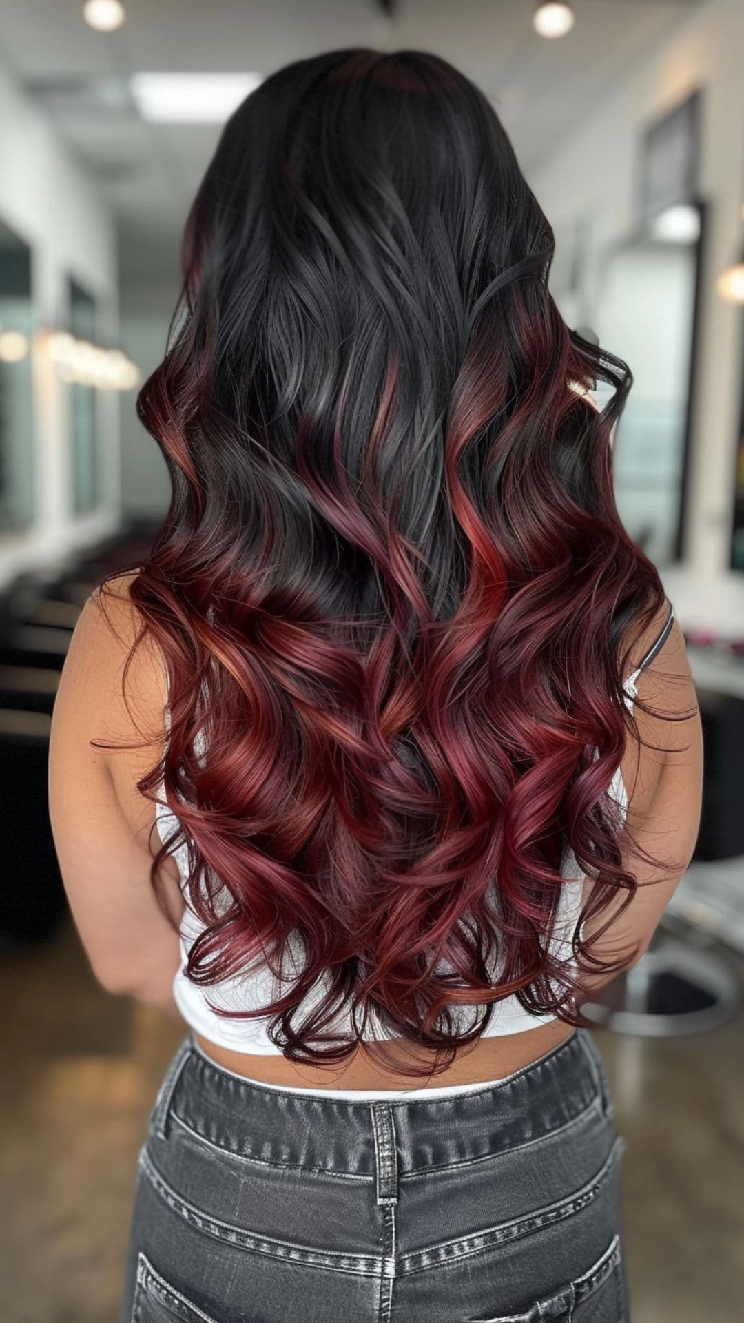 A woman modelling a black to burgundy ombre hair.