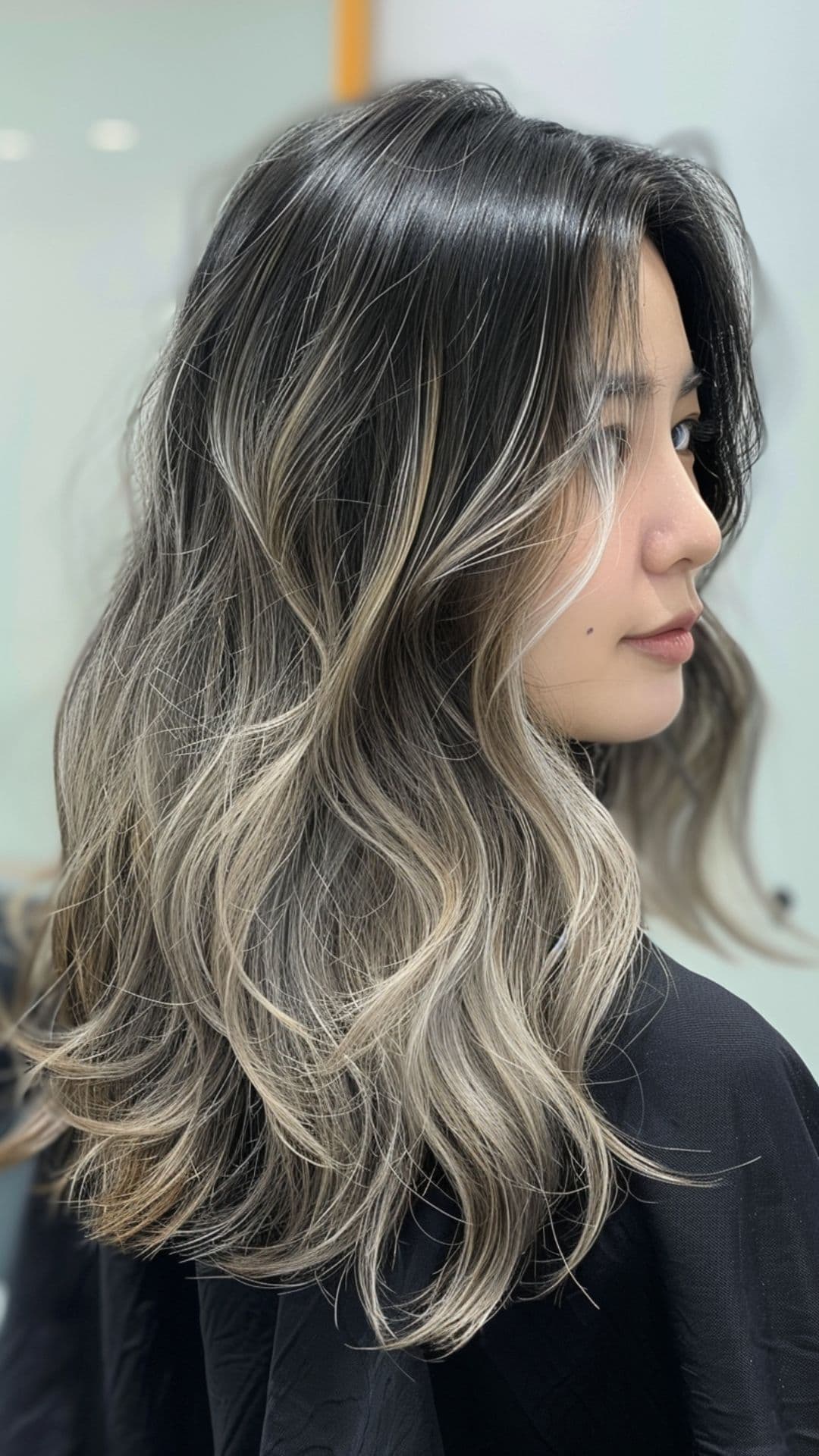 A woman modelling a charcoal gray hair.