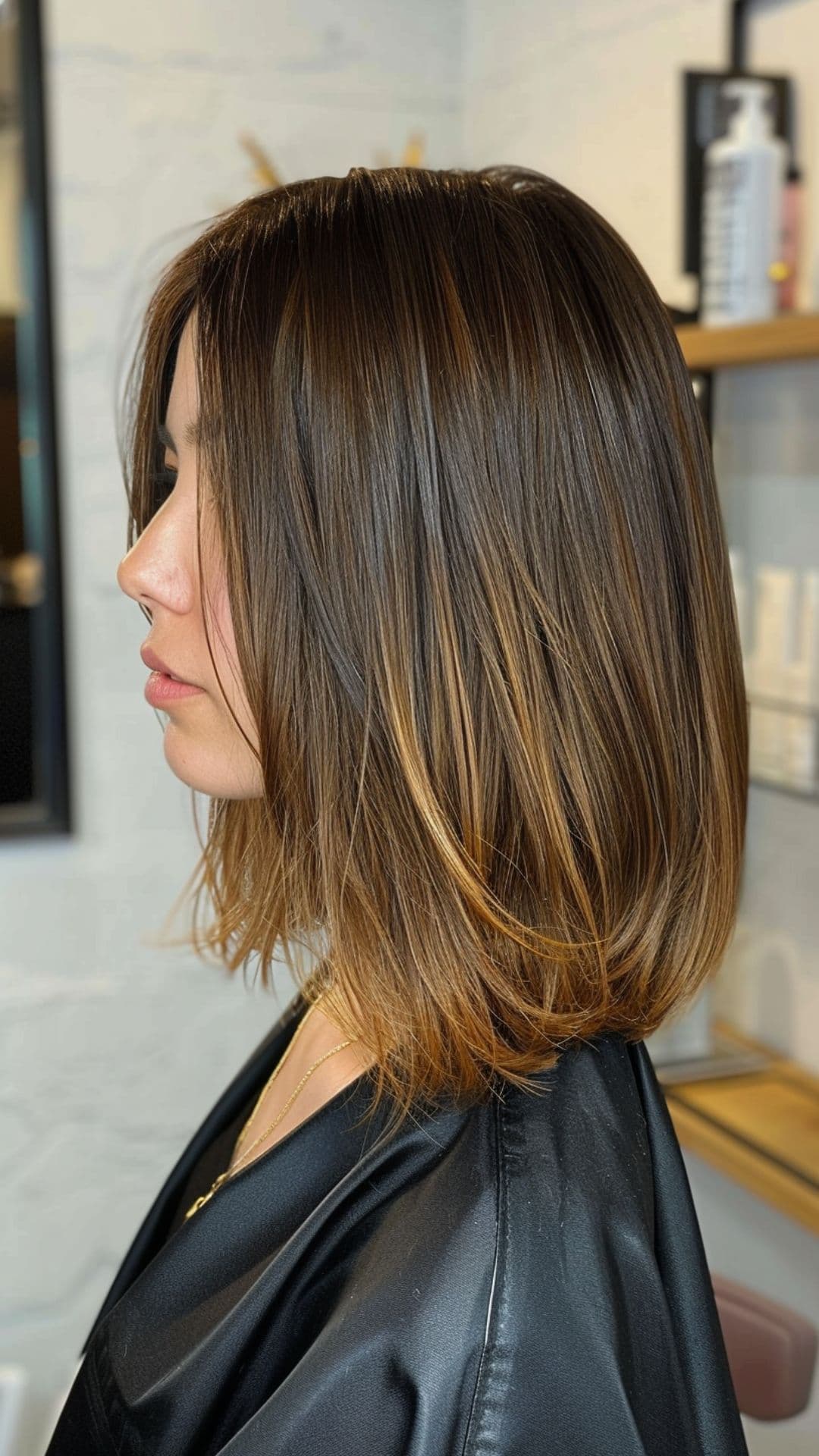 A woman modelling a chocolate to caramel ombre hair.