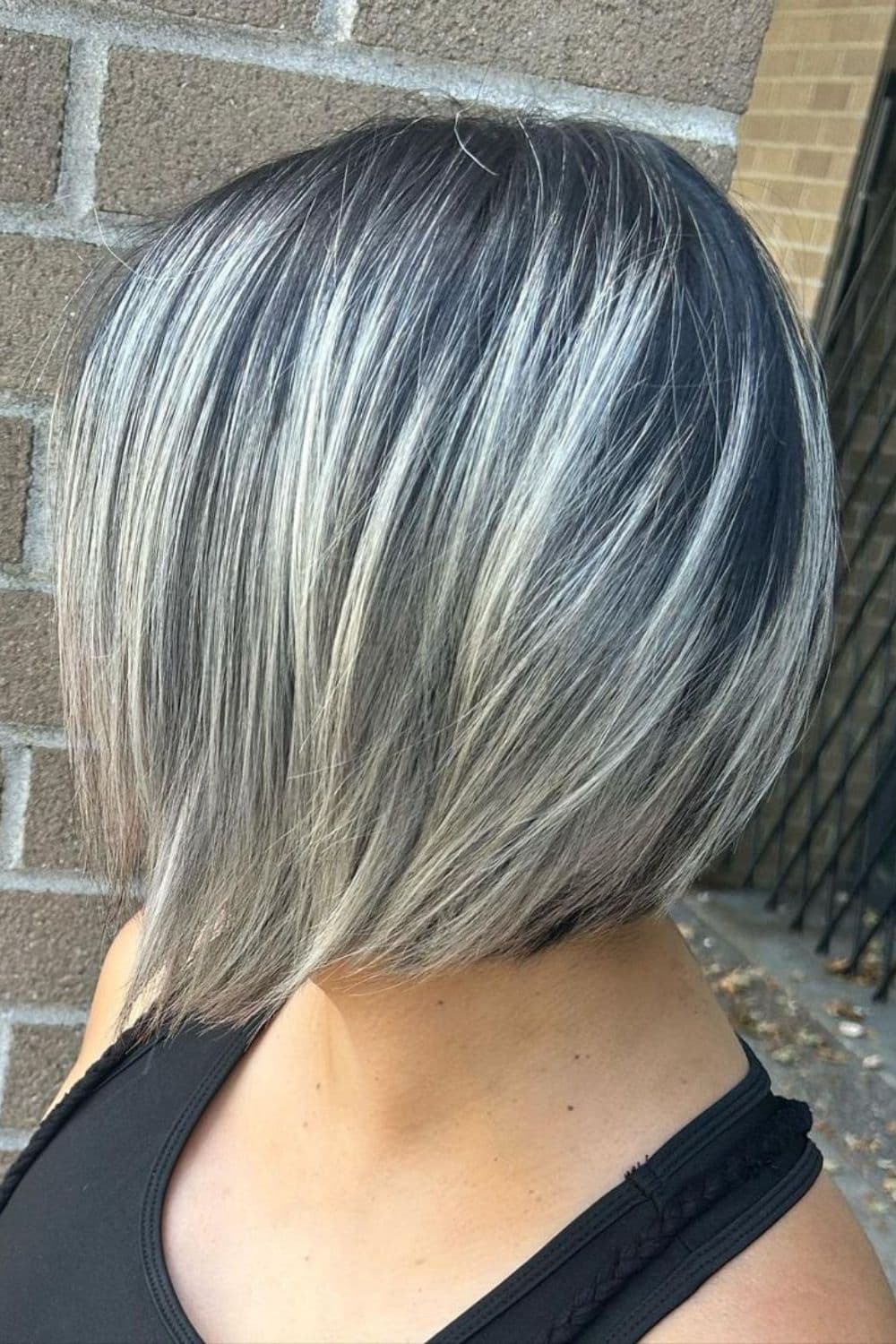 A woman with ice-white choppy angled bob cut.