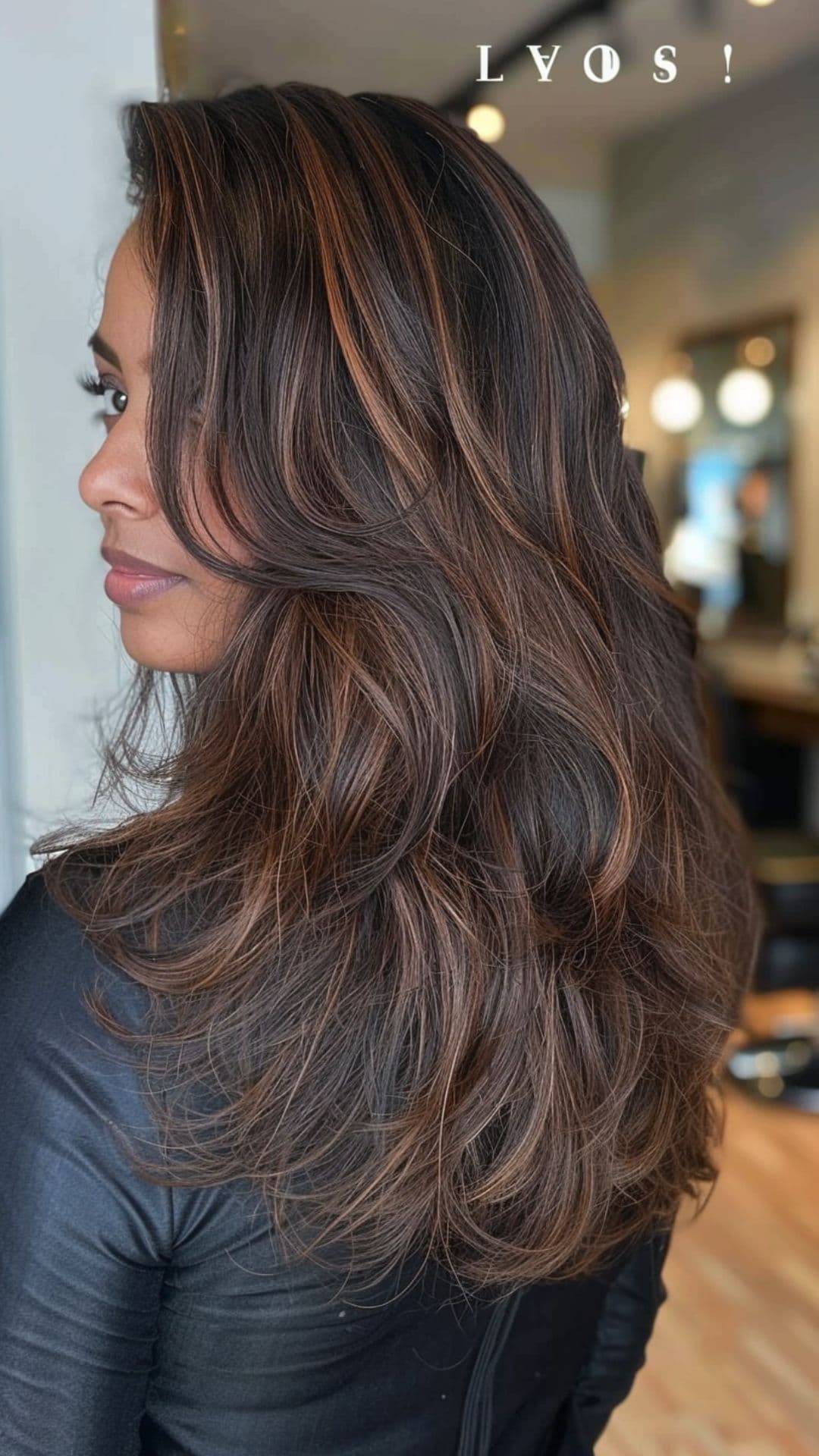 A woman modelling a black hair with chestnut highlights.