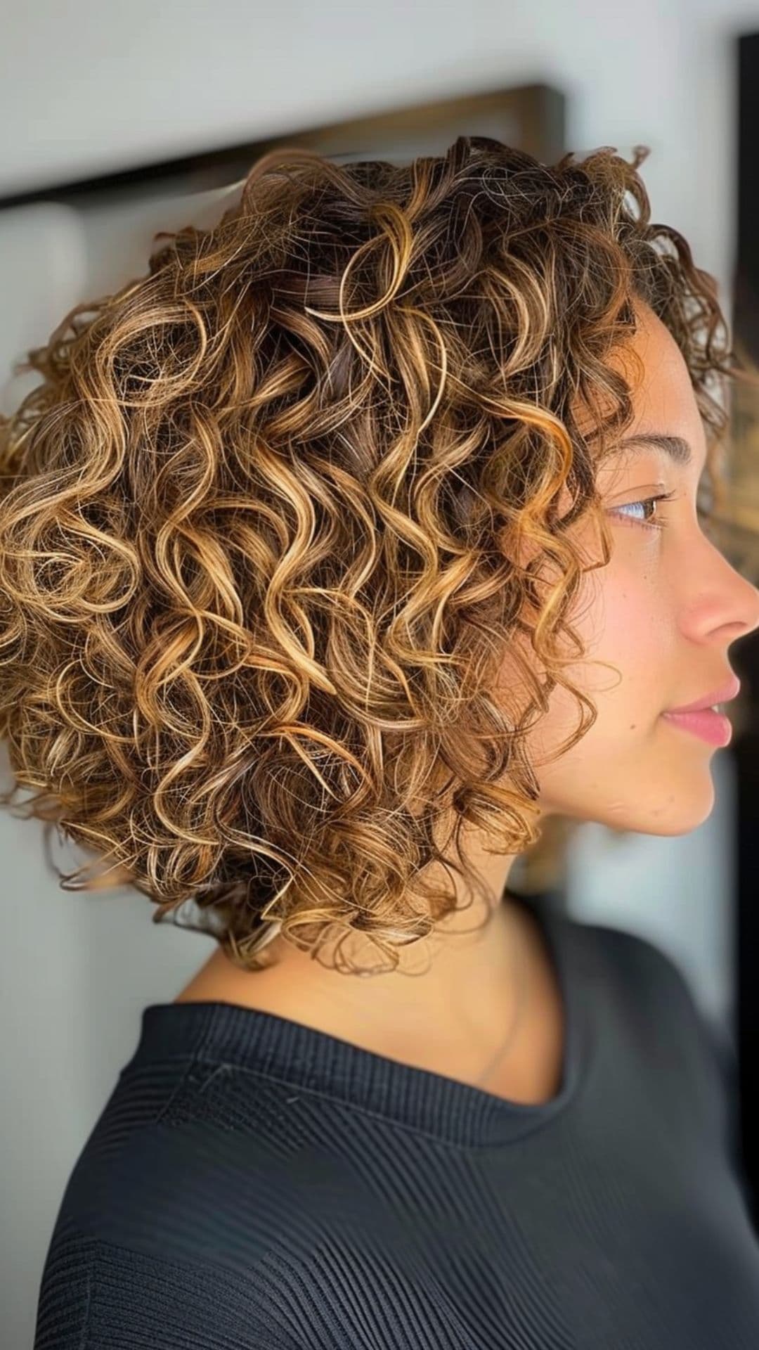 A woman modelling a curly inverted bob.