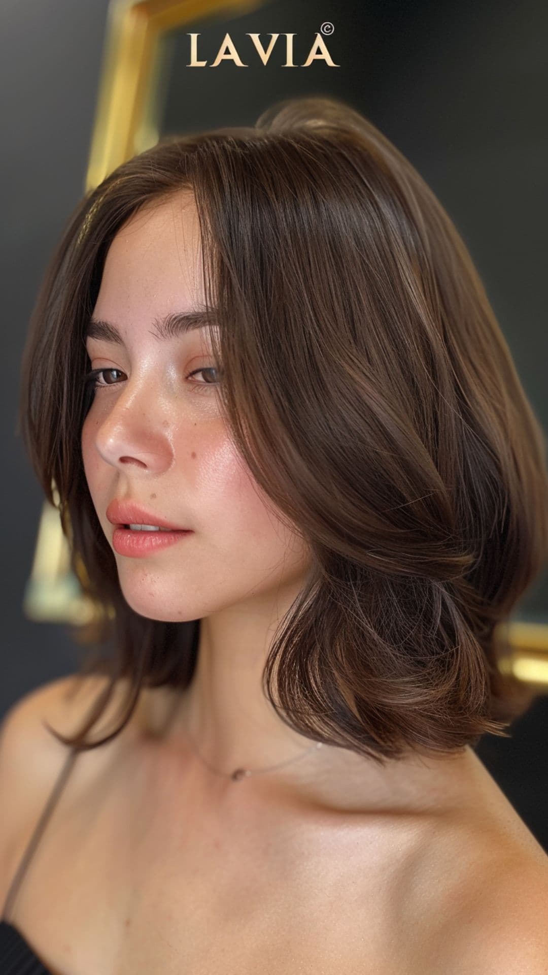 A woman modelling a dark ash brown hair.