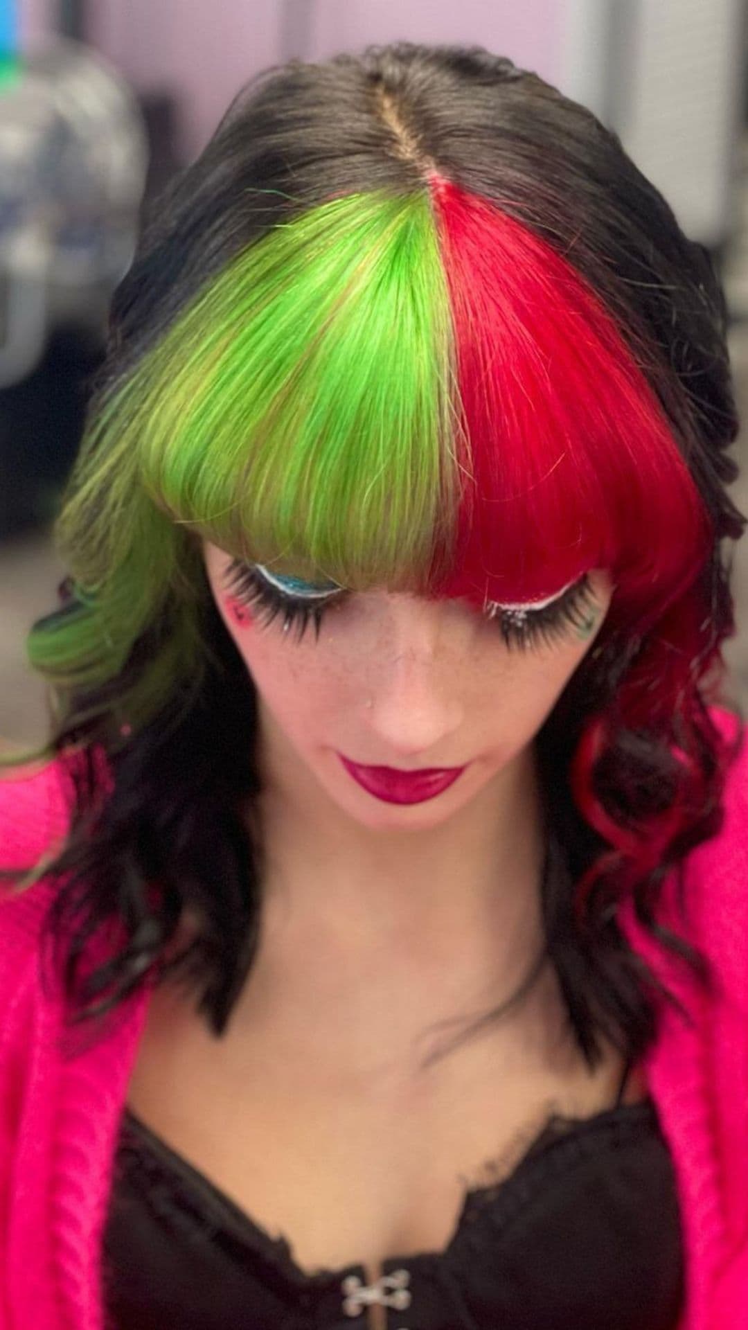 A woman modelling a Dark Hair with Split Dye Red and Green Bangs hairstyle.