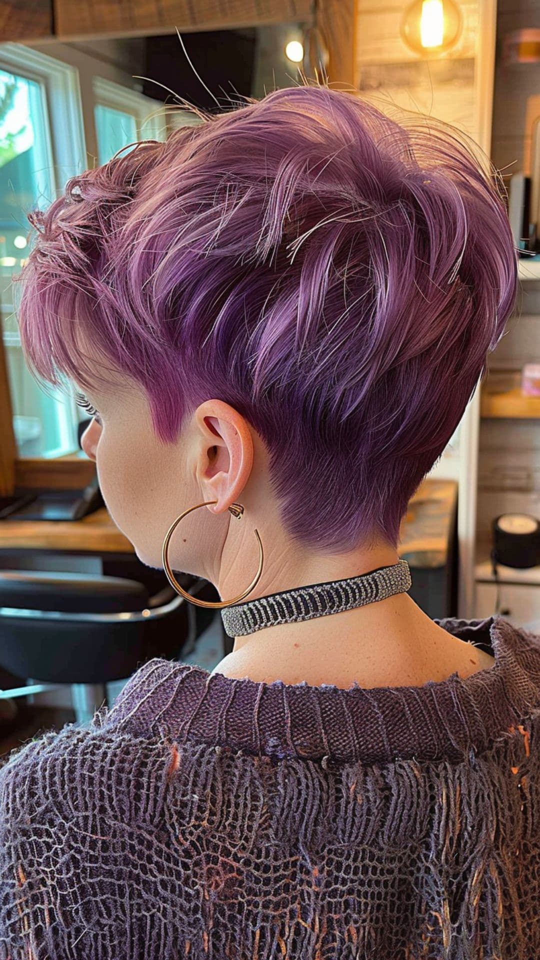 A woman modelling a dark to light purple ombre hair.