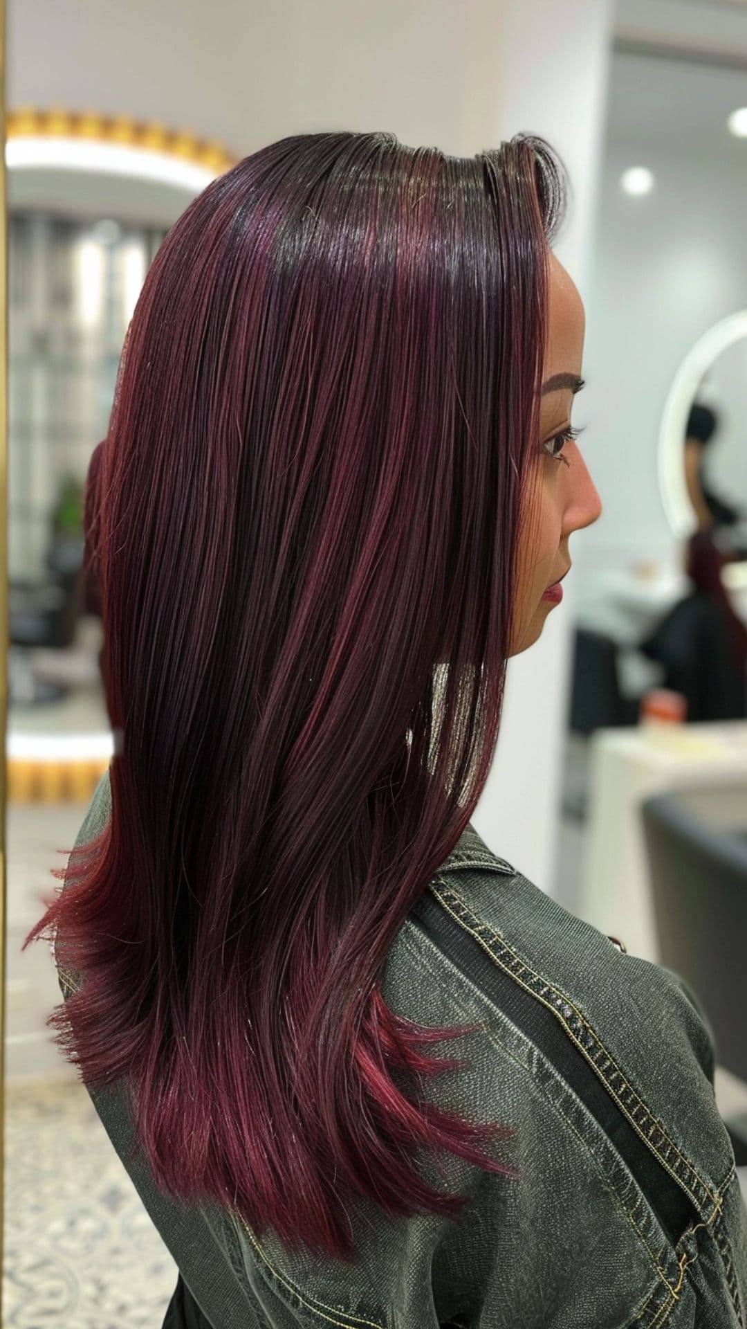 A woman modelling a black hair with burgundy highlights.