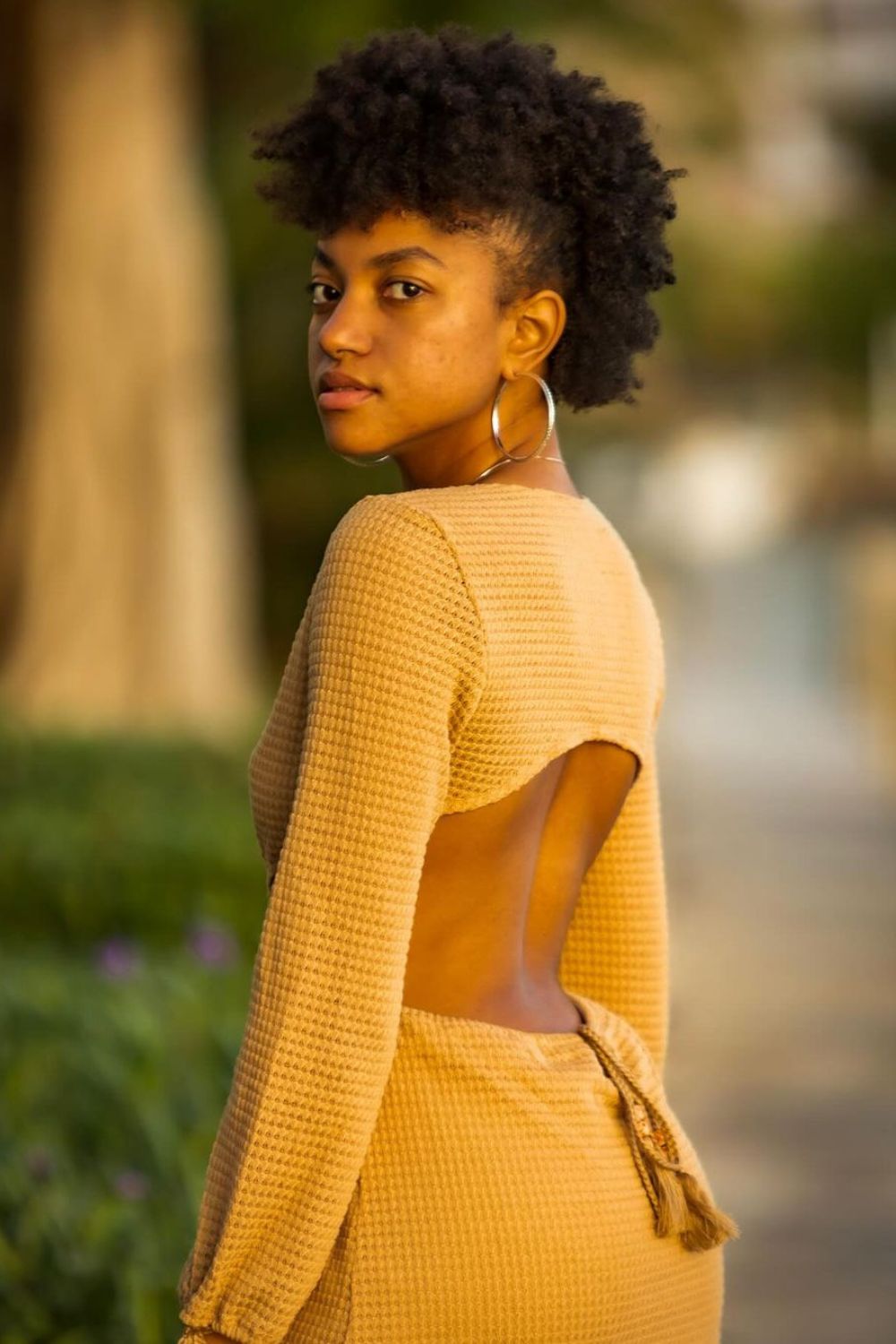 A woman with a black frohawk.