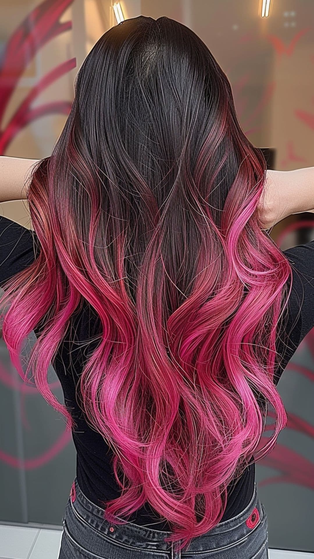 A woman modelling a black to hot pink ombre hair.