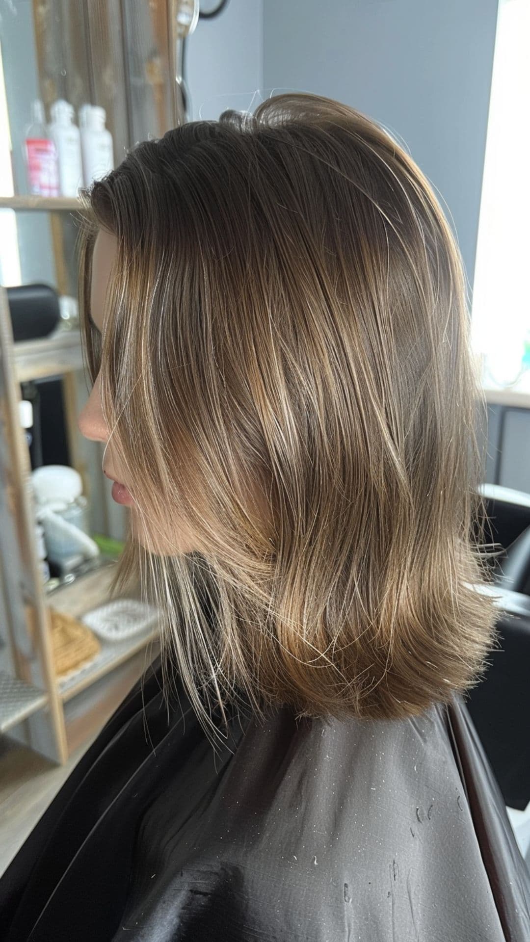 A woman modelling an icy brown hair.