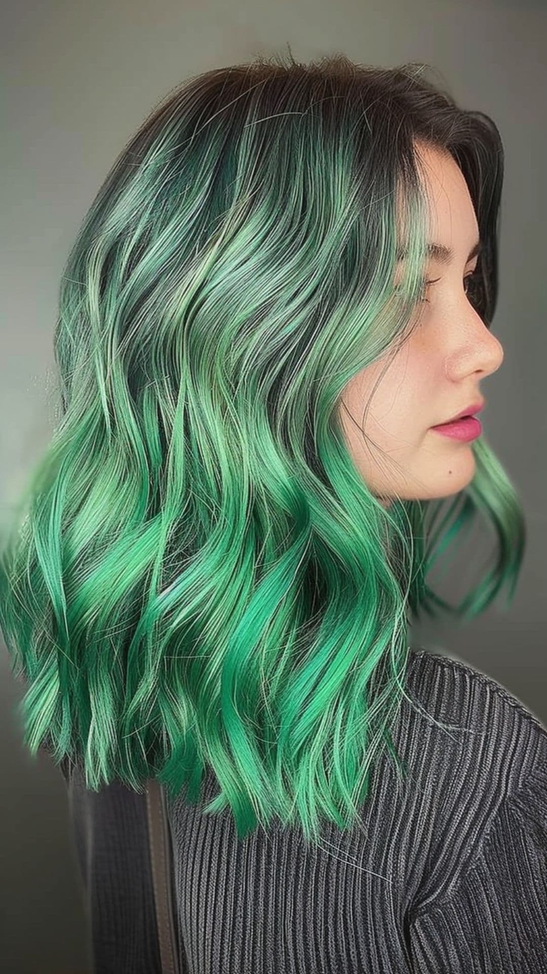 A woman modelling an iris green and phantom green ombre balayage hair.