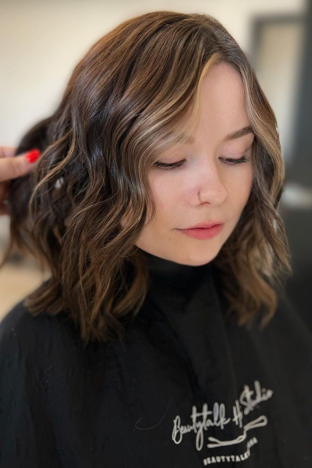 A woman with a long bob balayage.