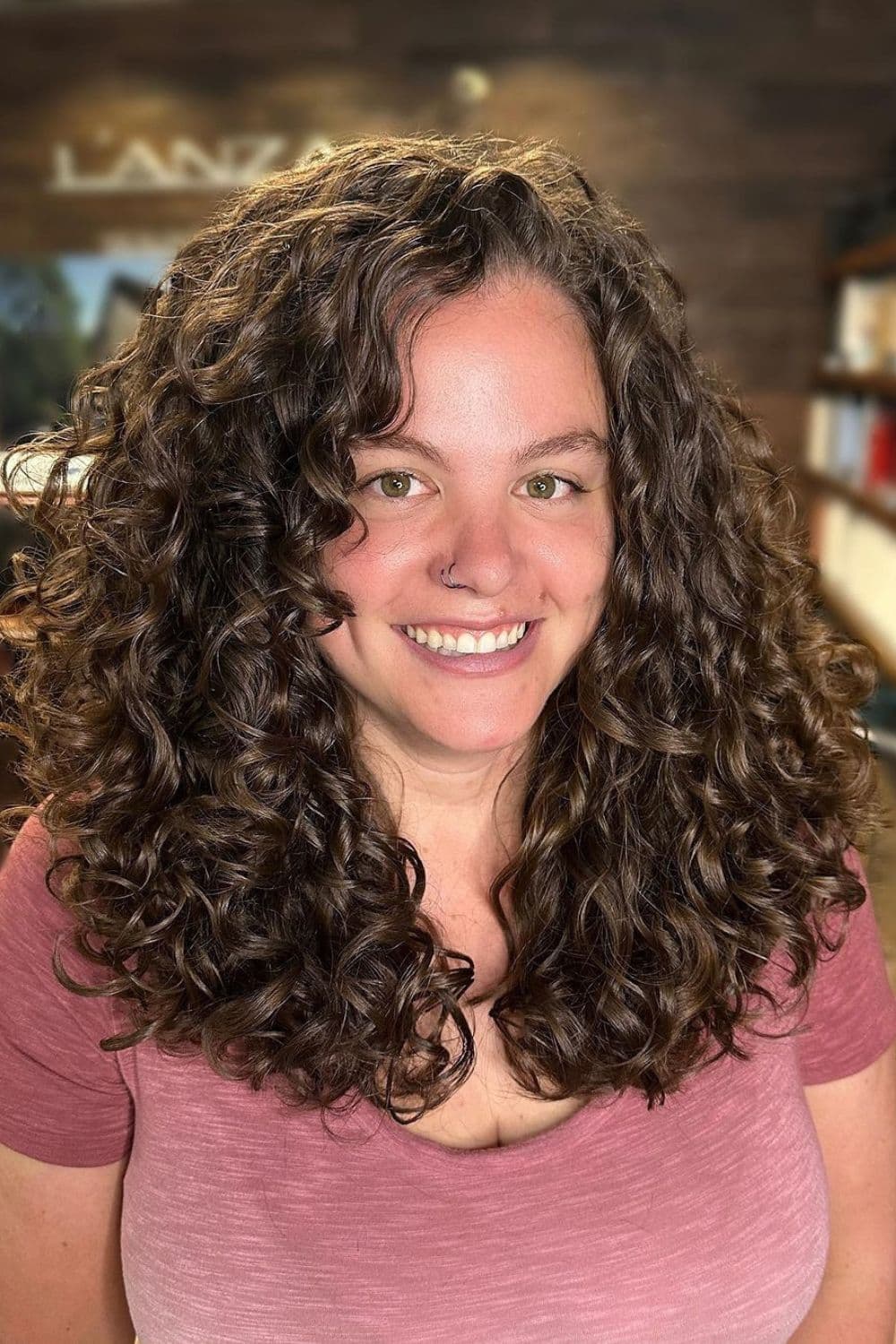 A woman with a long brown RëZO cut.