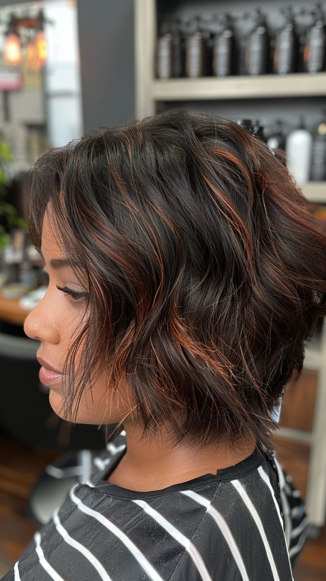 A woman modelling a black hair with auburn highlights.