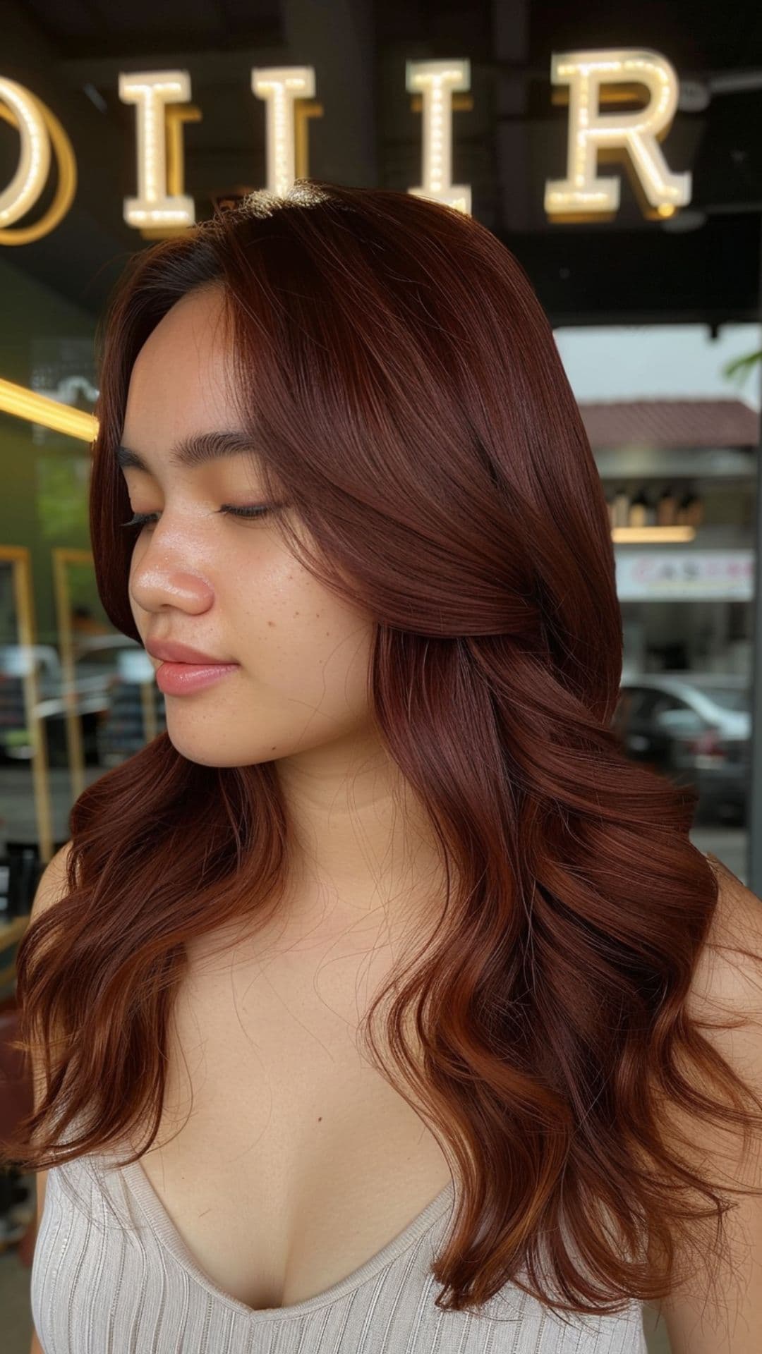 A woman modelling a mahogany auburn hair.