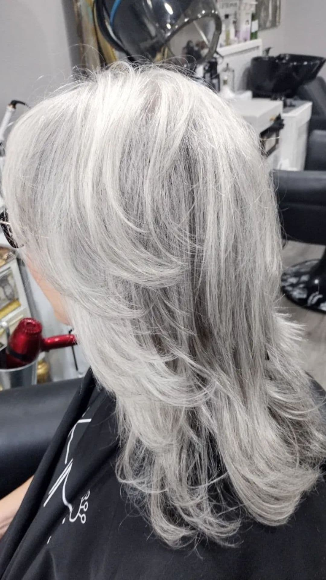 An older woman modelling a medium shag cut with feathered layers hairstyle.