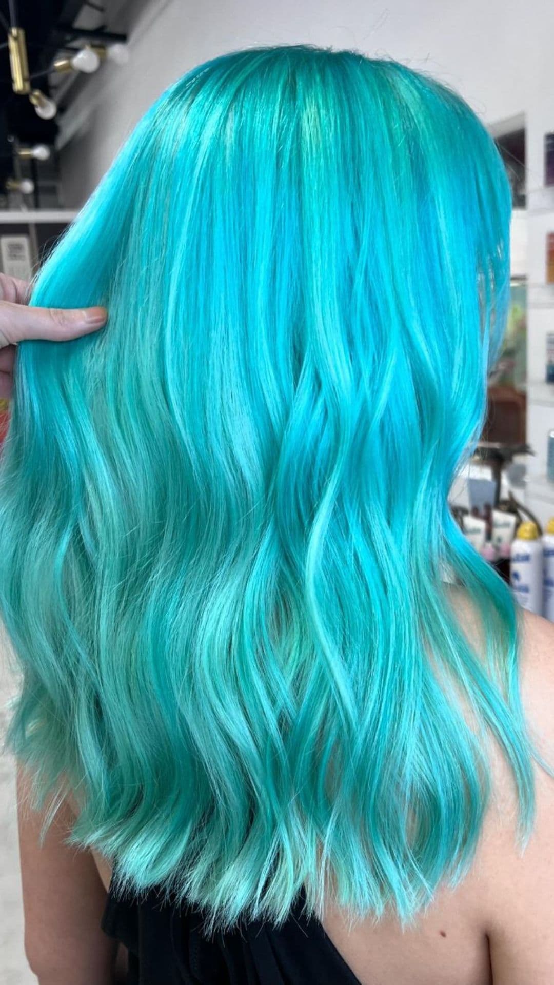 Person with Marine Mint Strands hairstyle showing vibrant turquoise waves.