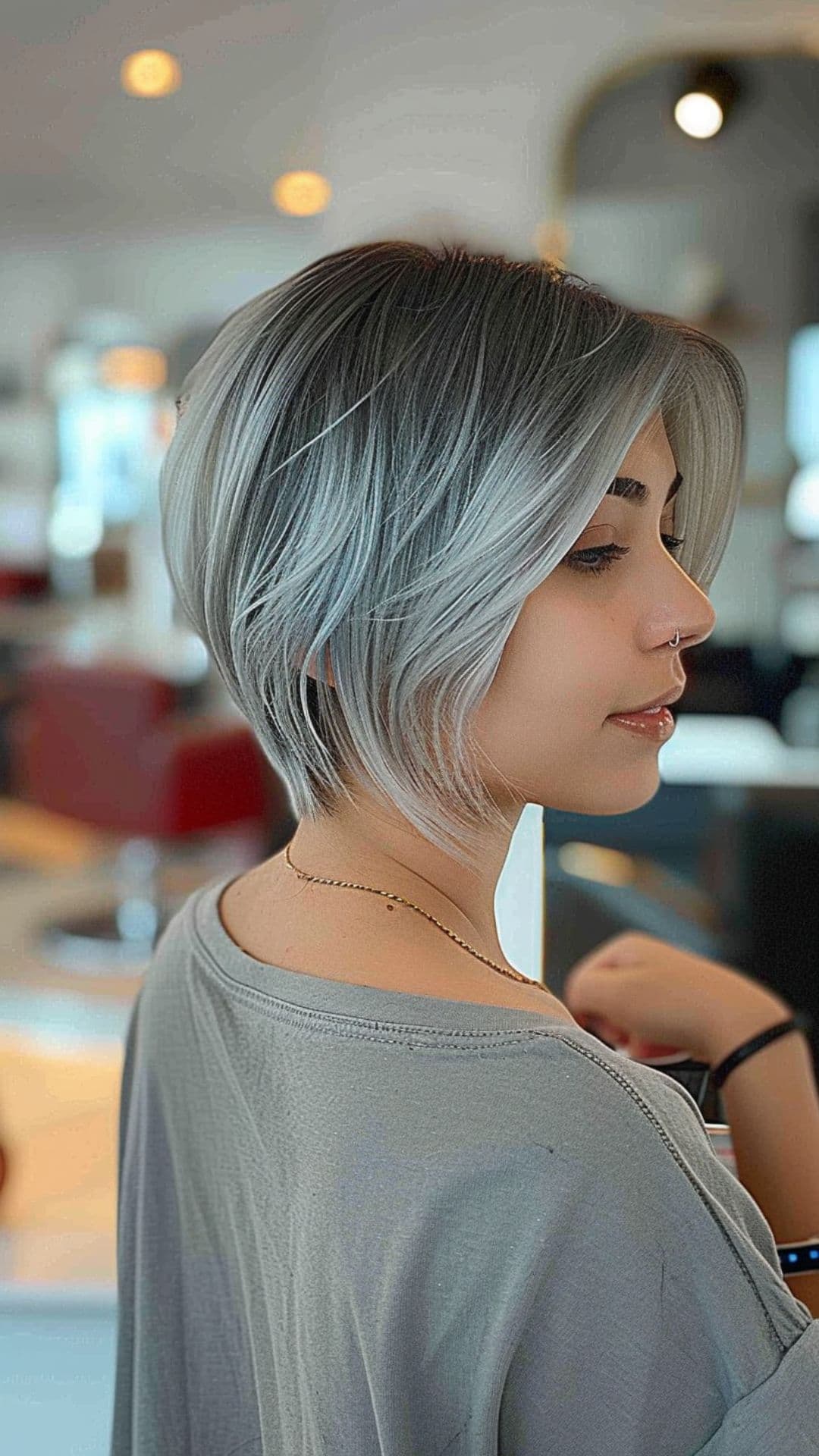 A woman modelling a metallic gray ombre hairstyle.