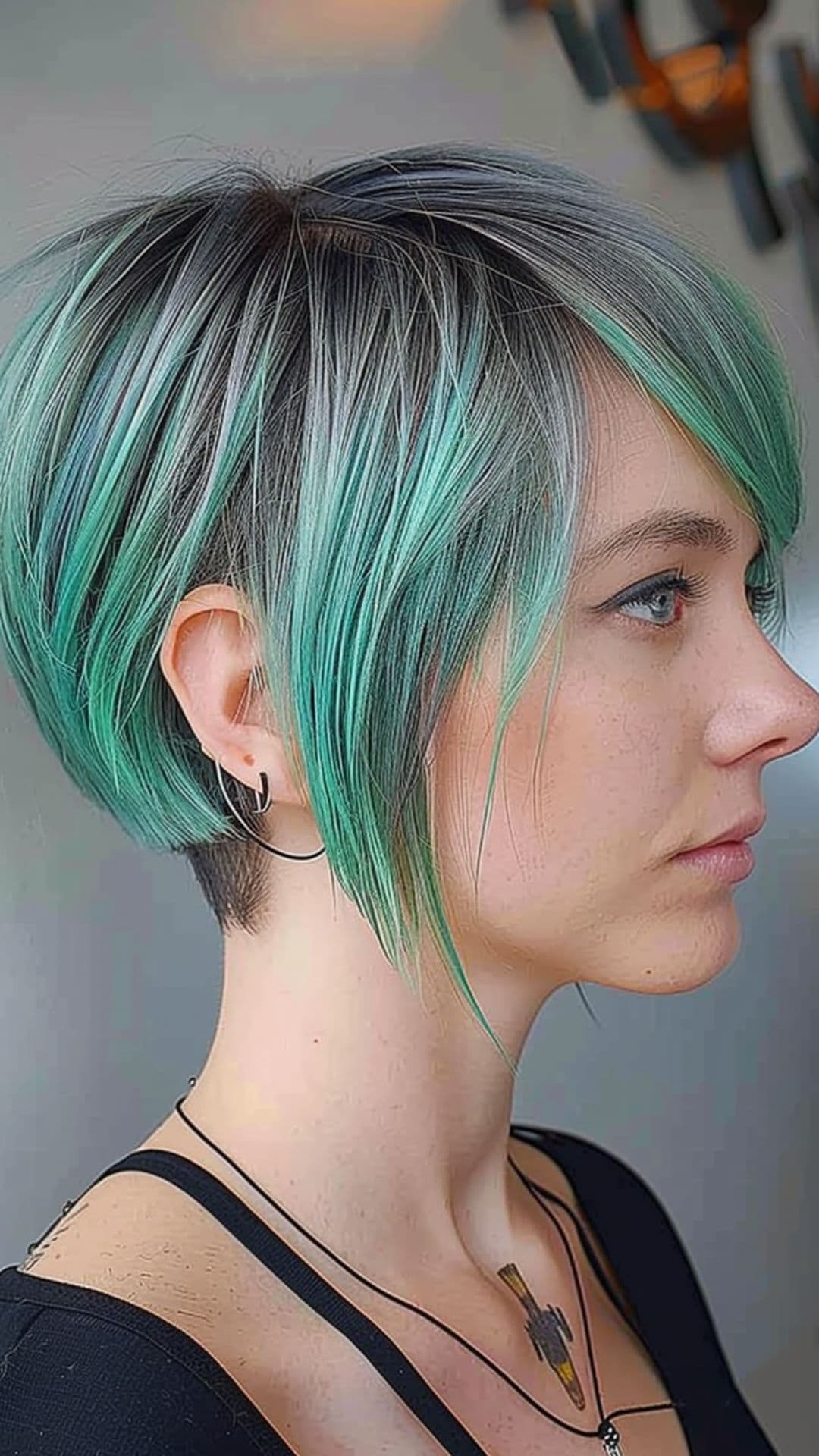 A woman modelling a mint green ombre hair.