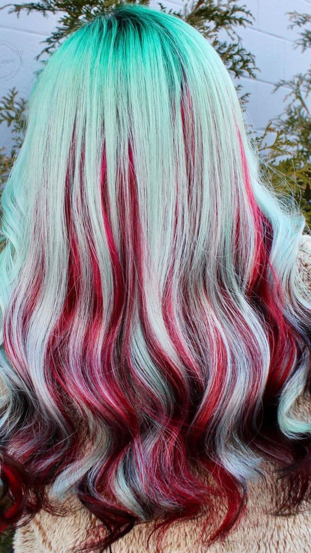 A woman modelling a Mint Green with Red Peek-a-boo Hair.