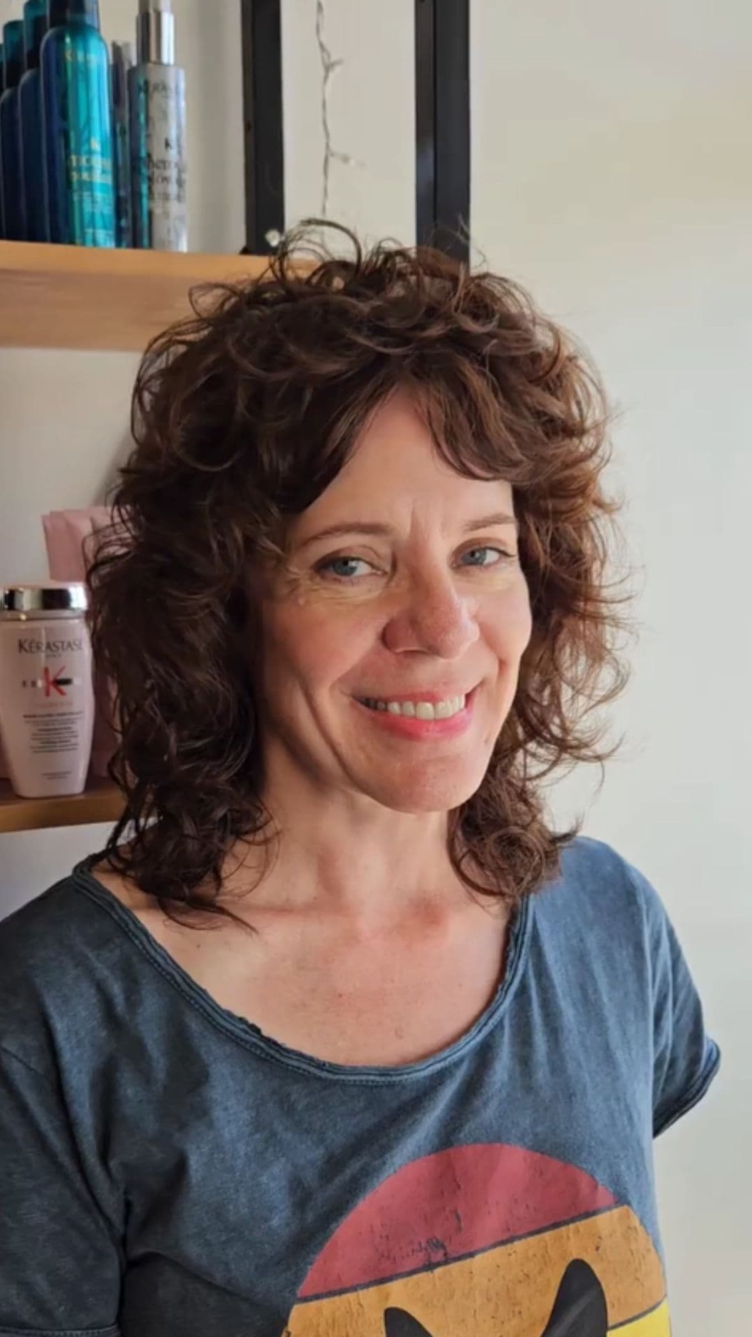 An older woman modelling a modern wavy shag hairstyle.