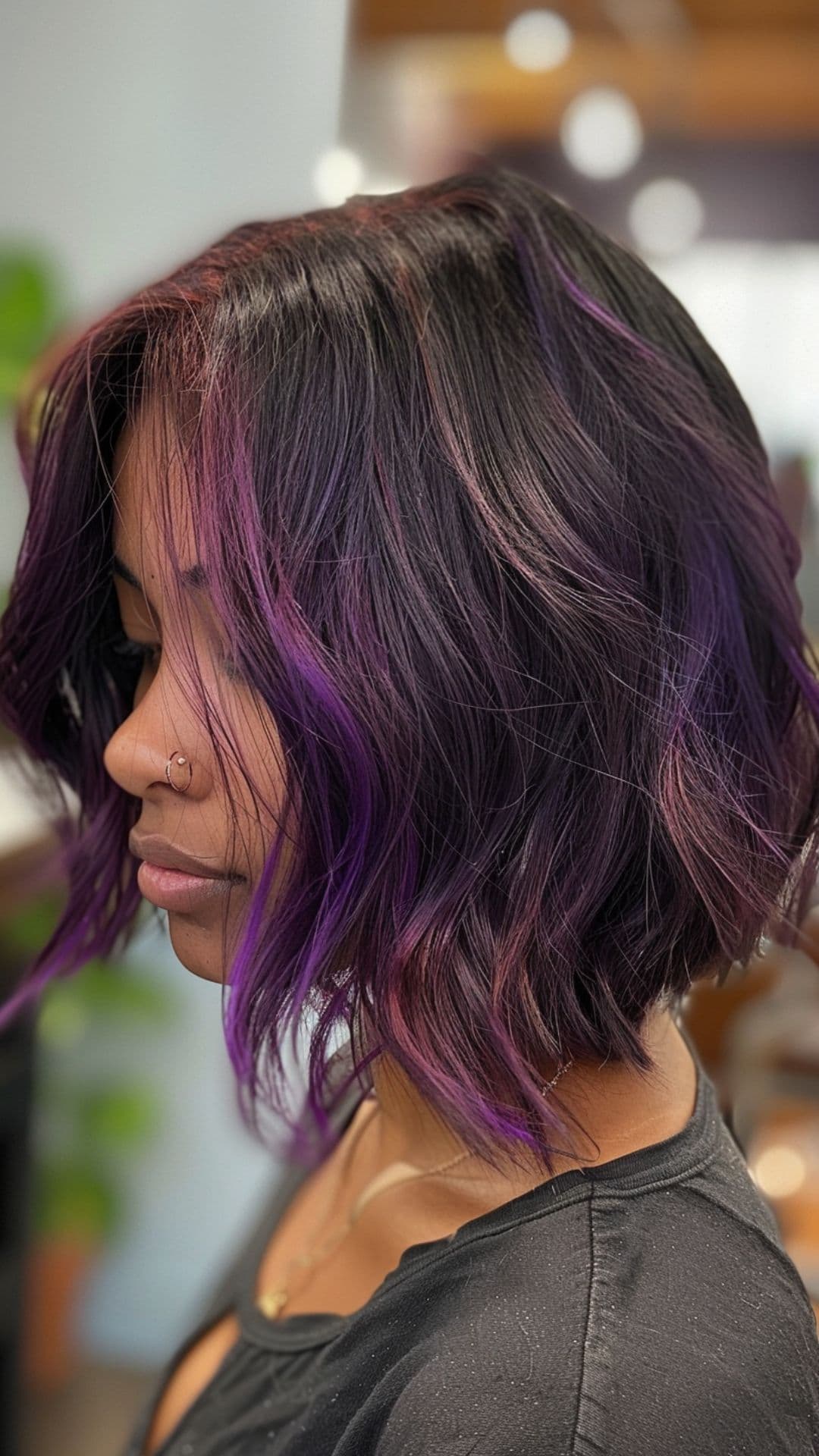 A woman modelling a black hair with purple highlights.