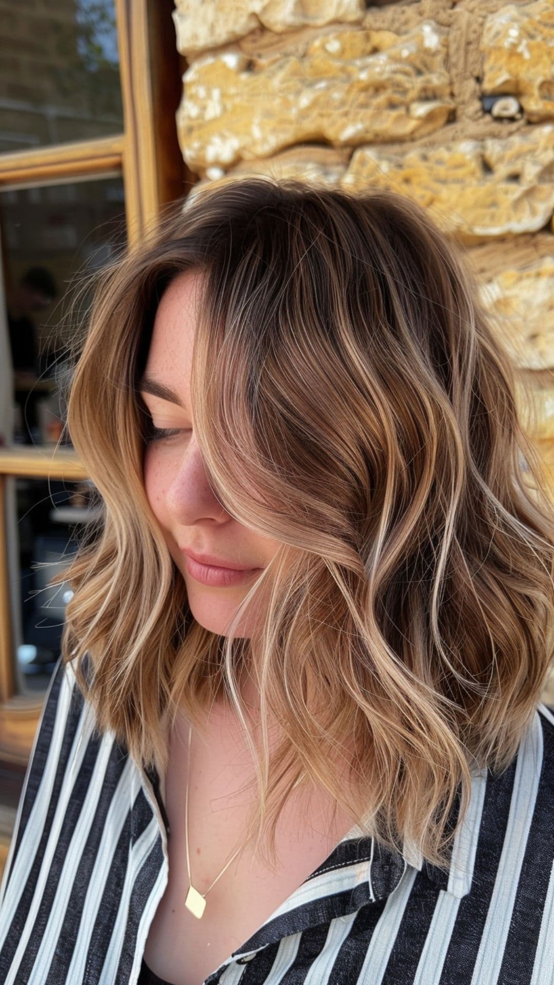 A woman modelling a peach blonde highlights hair.