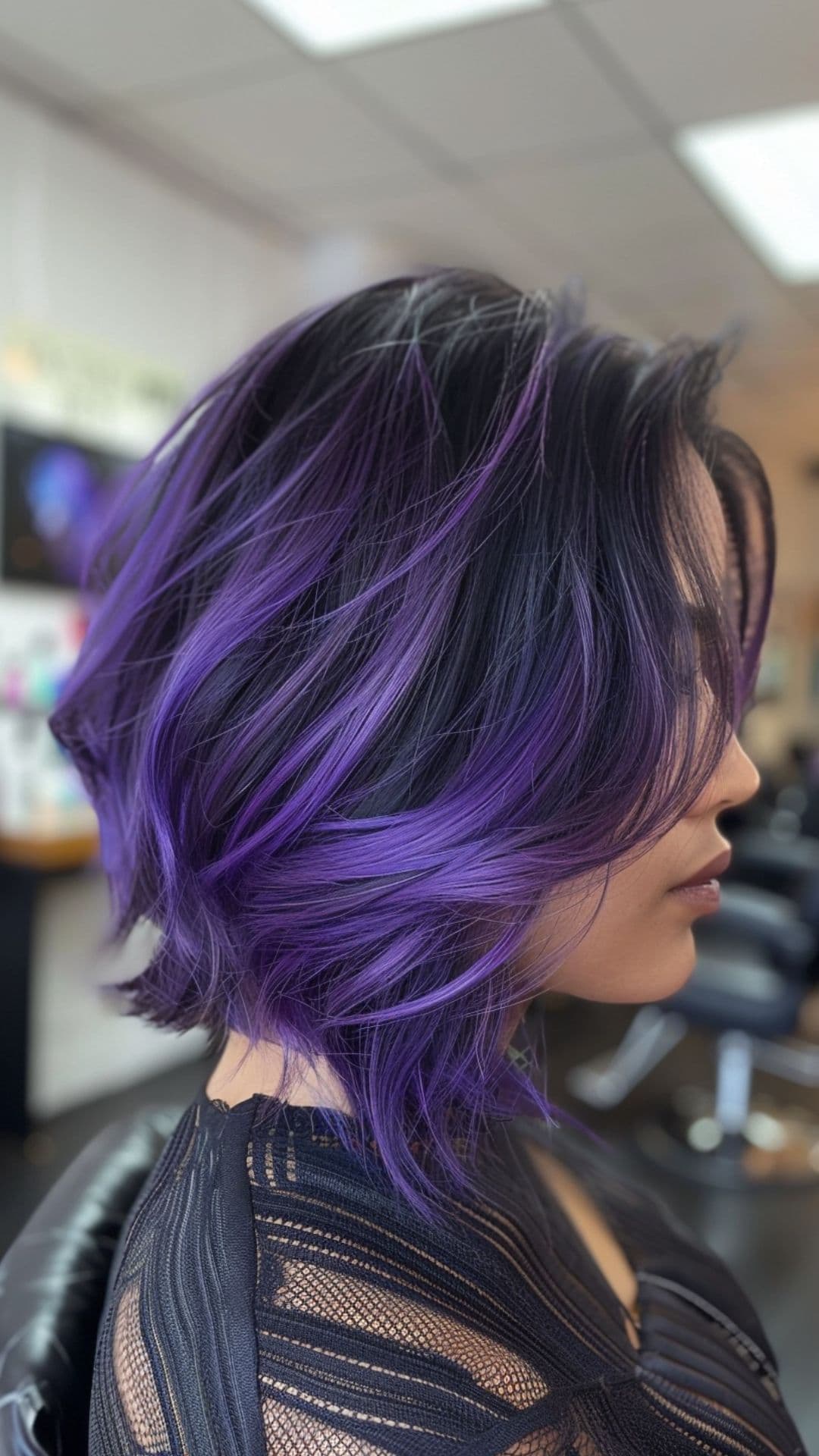 A woman modelling a purple chunky highlights hair.