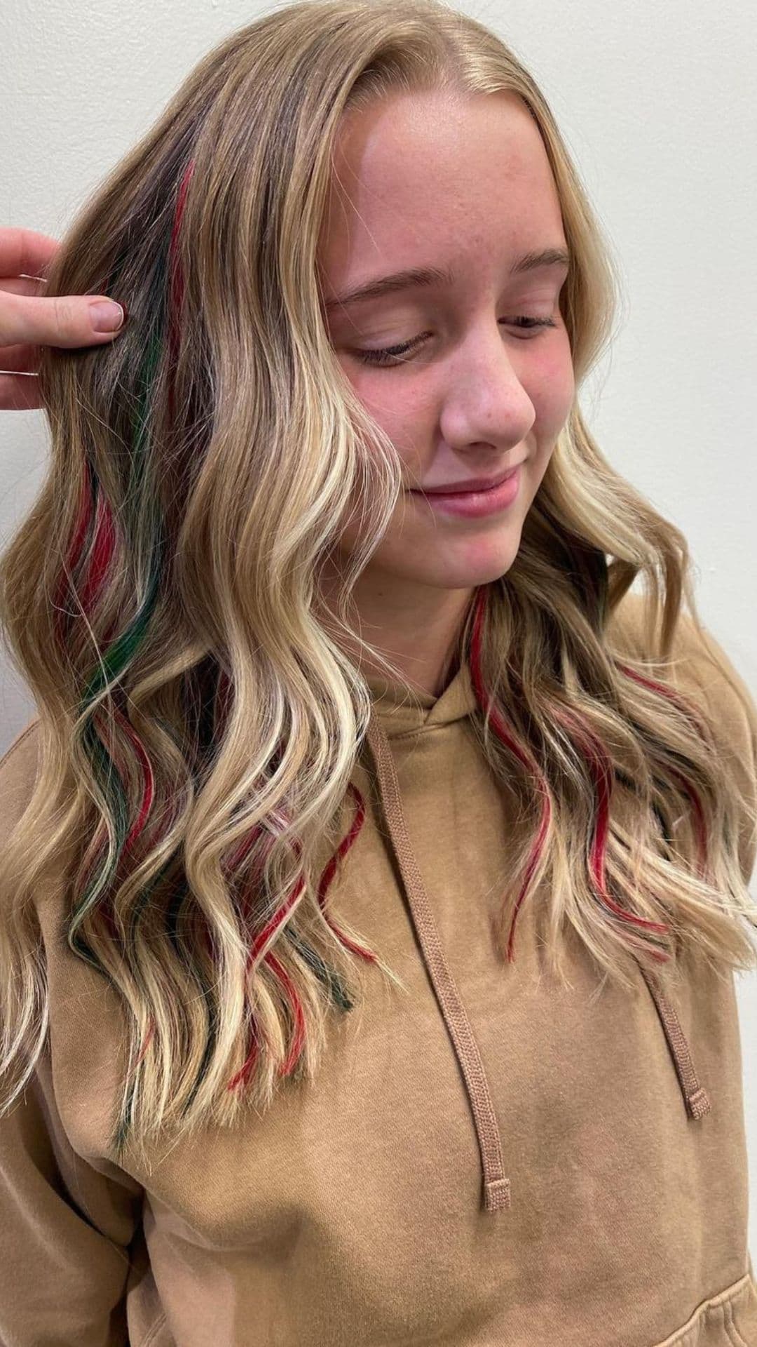 A woman modelling a Red and Green Highlights hairstyle.