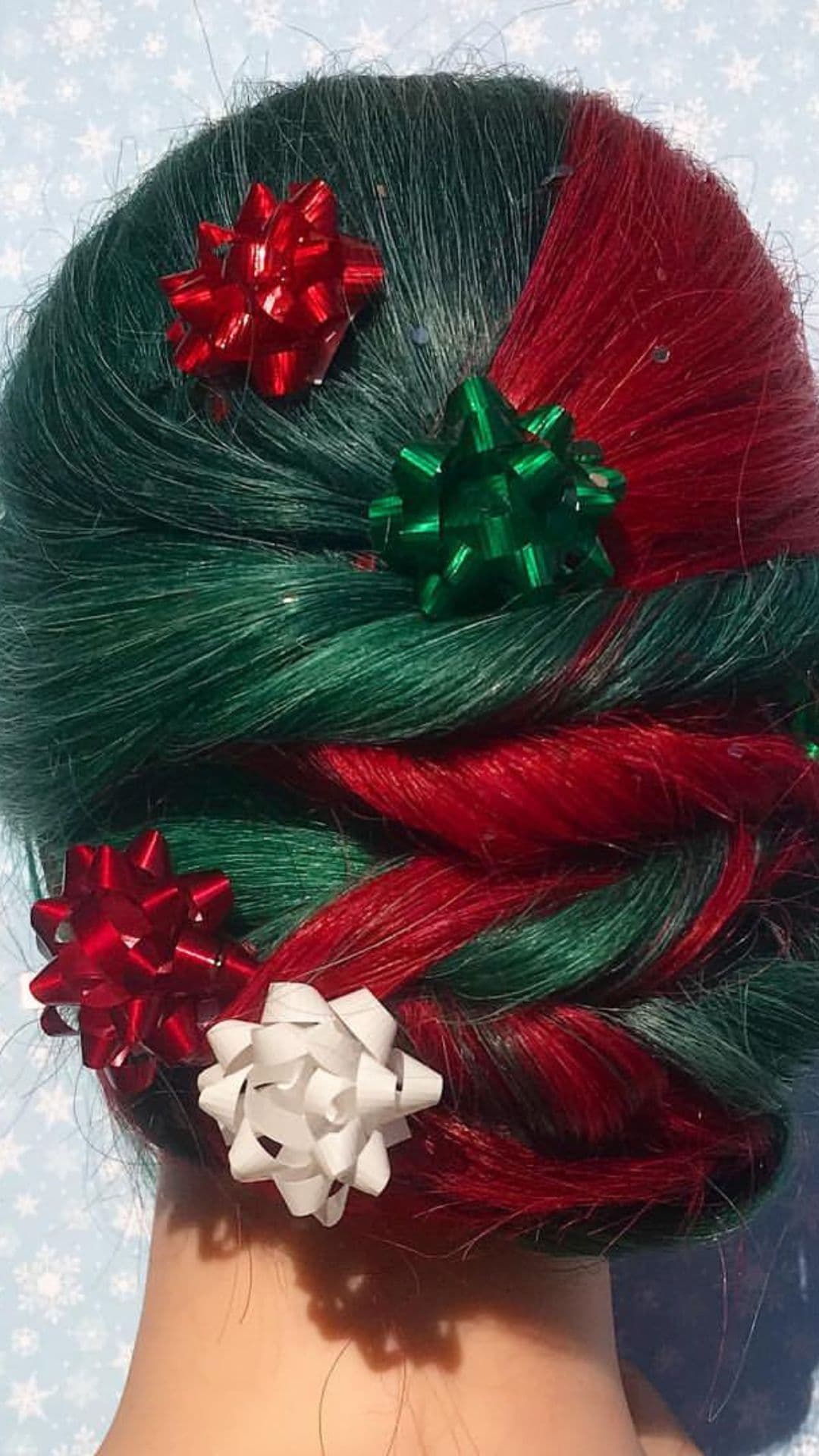 A woman modelling a Red and Green Twisted Bun with Ribbons hairstyle.