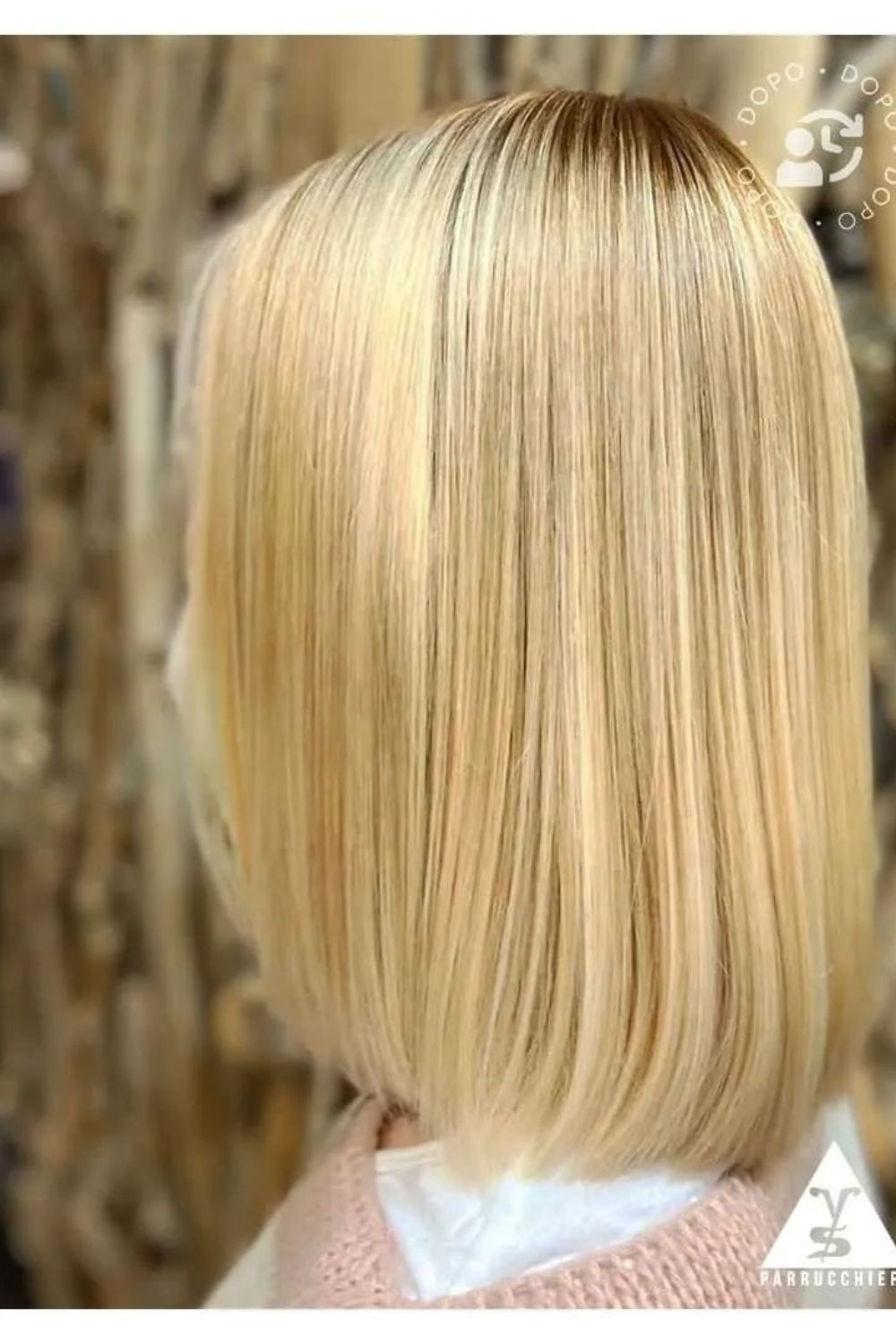 A woman with a blonde rounded lob.