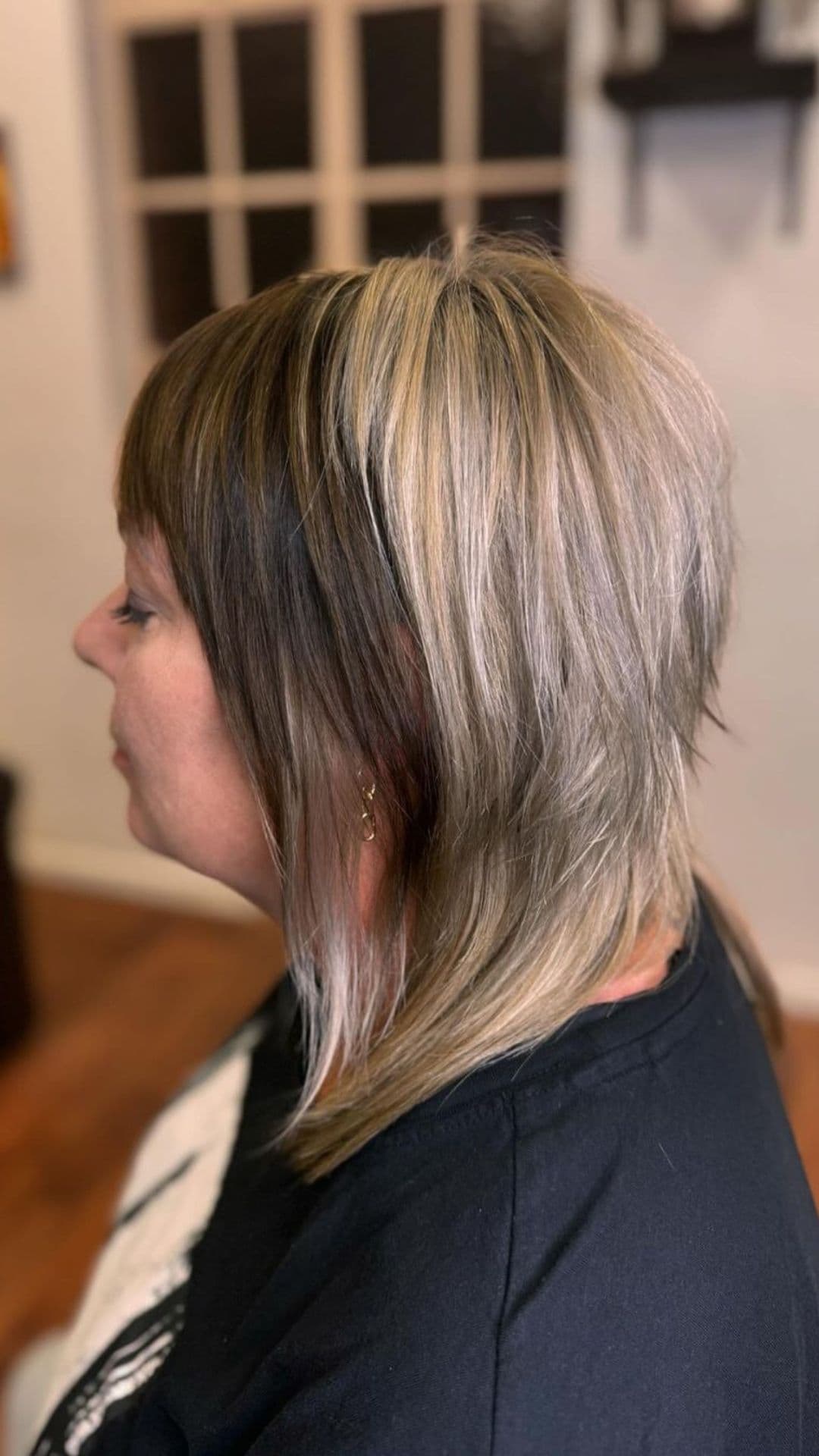 An older woman modelling a shaggy haircut for fine hair.