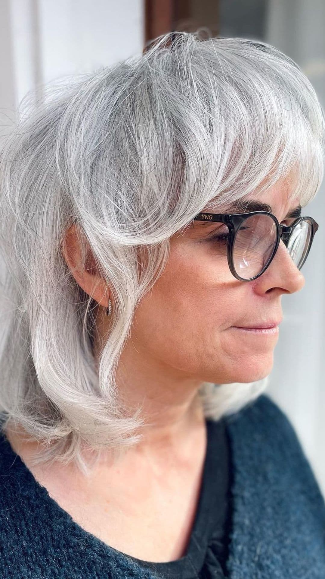 An older woman modelling a shaggy wolf cut hairstyle.