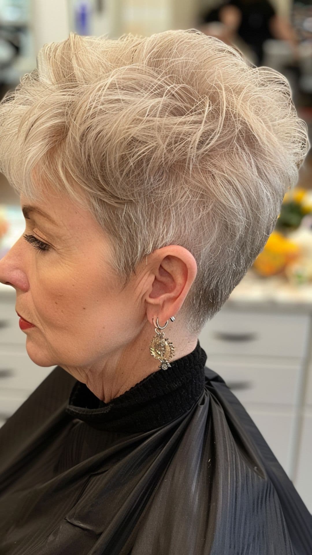 An old woman modelling a silver blonde pixie hair.