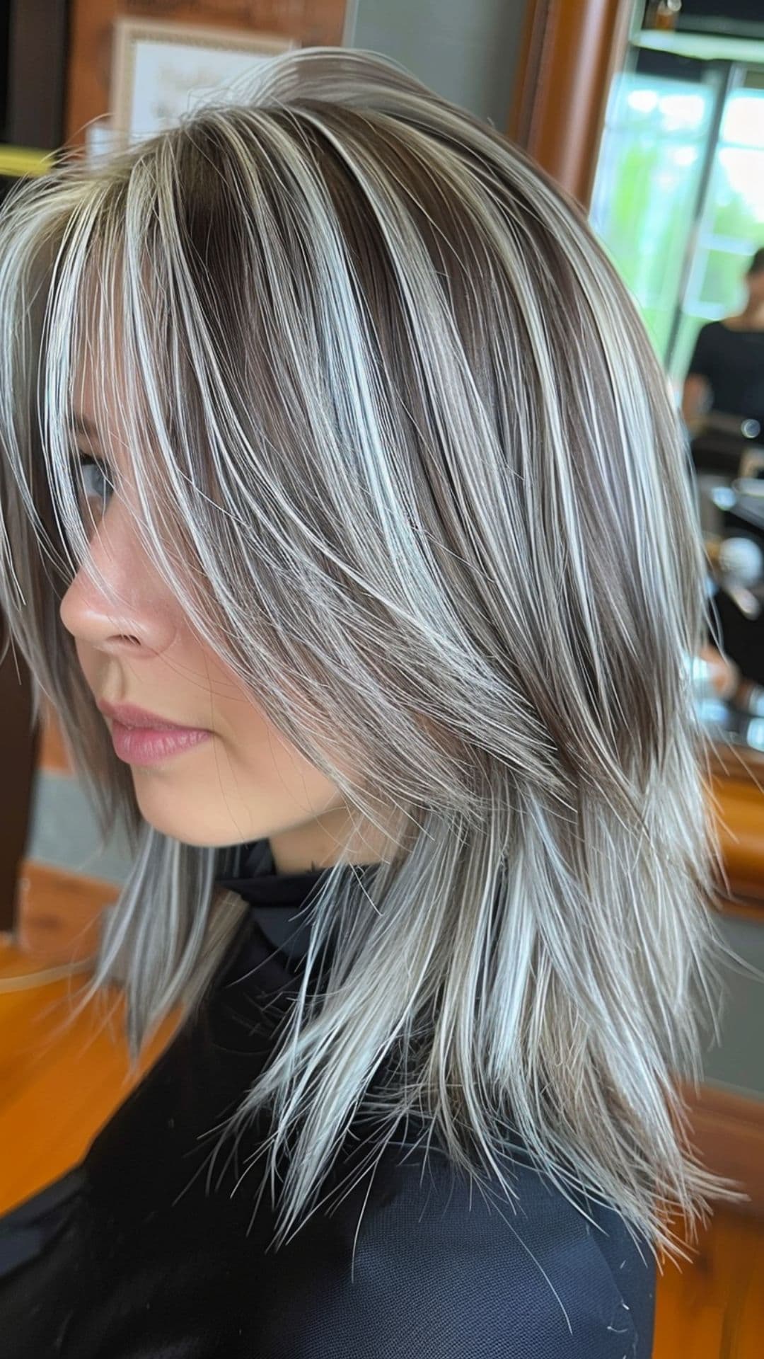 A woman modelling a silver chunky highlights hair.