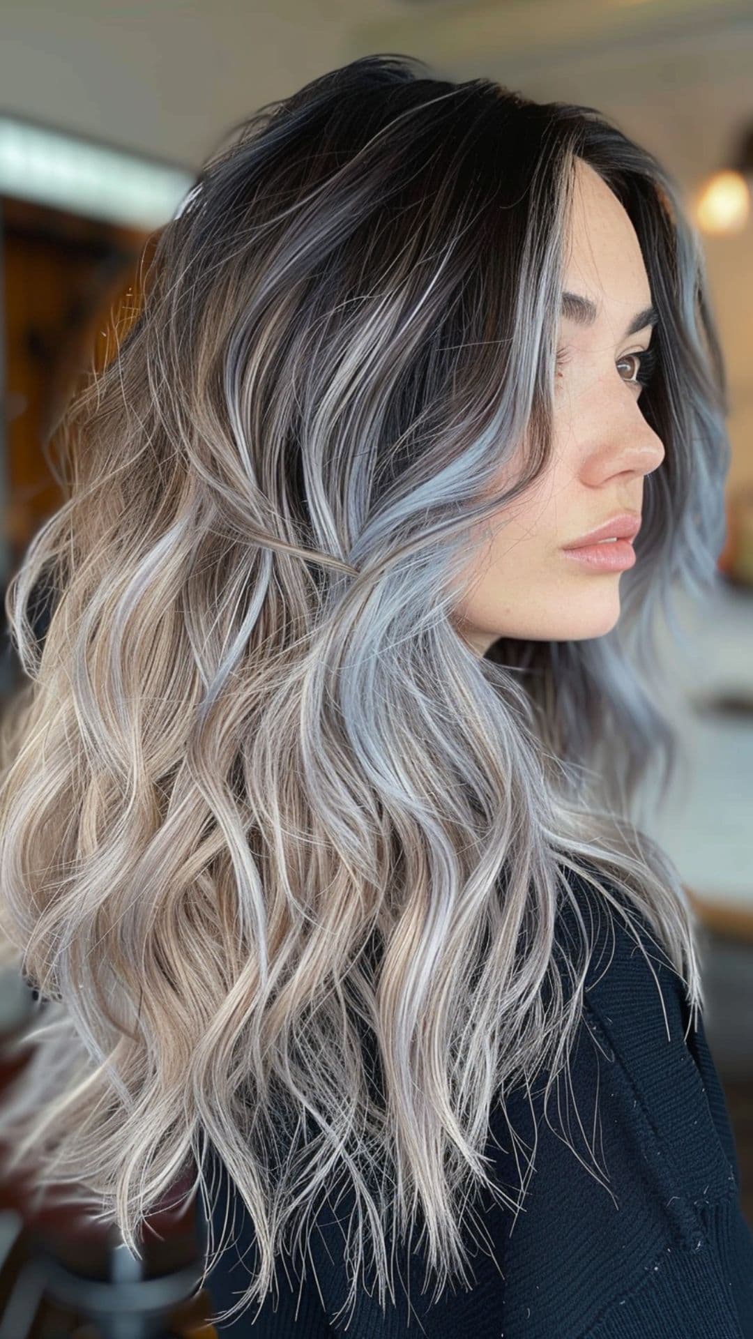 A woman modelling a black to silver ombre hair.