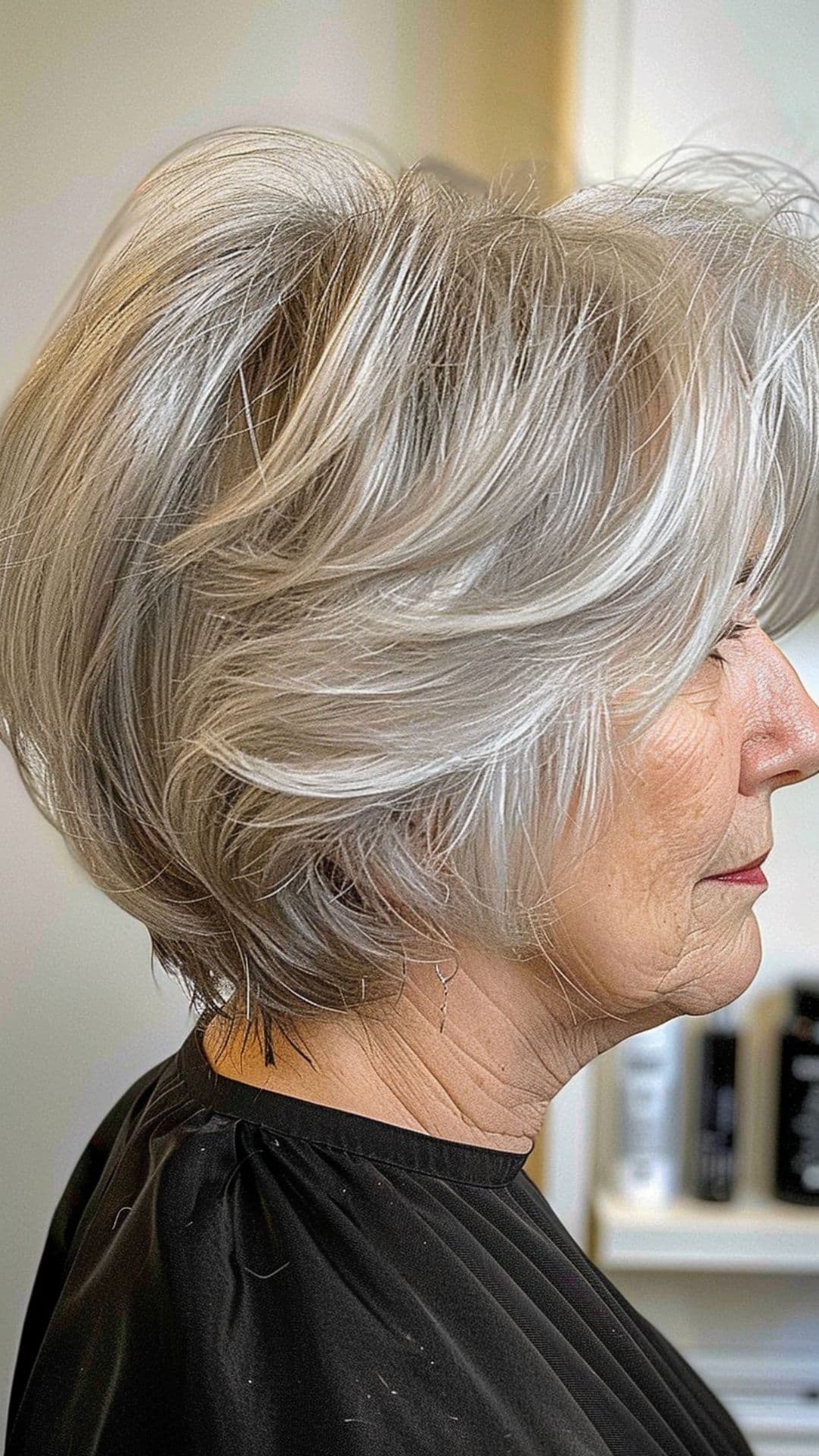 An old woman modelling a silver pixie bob.