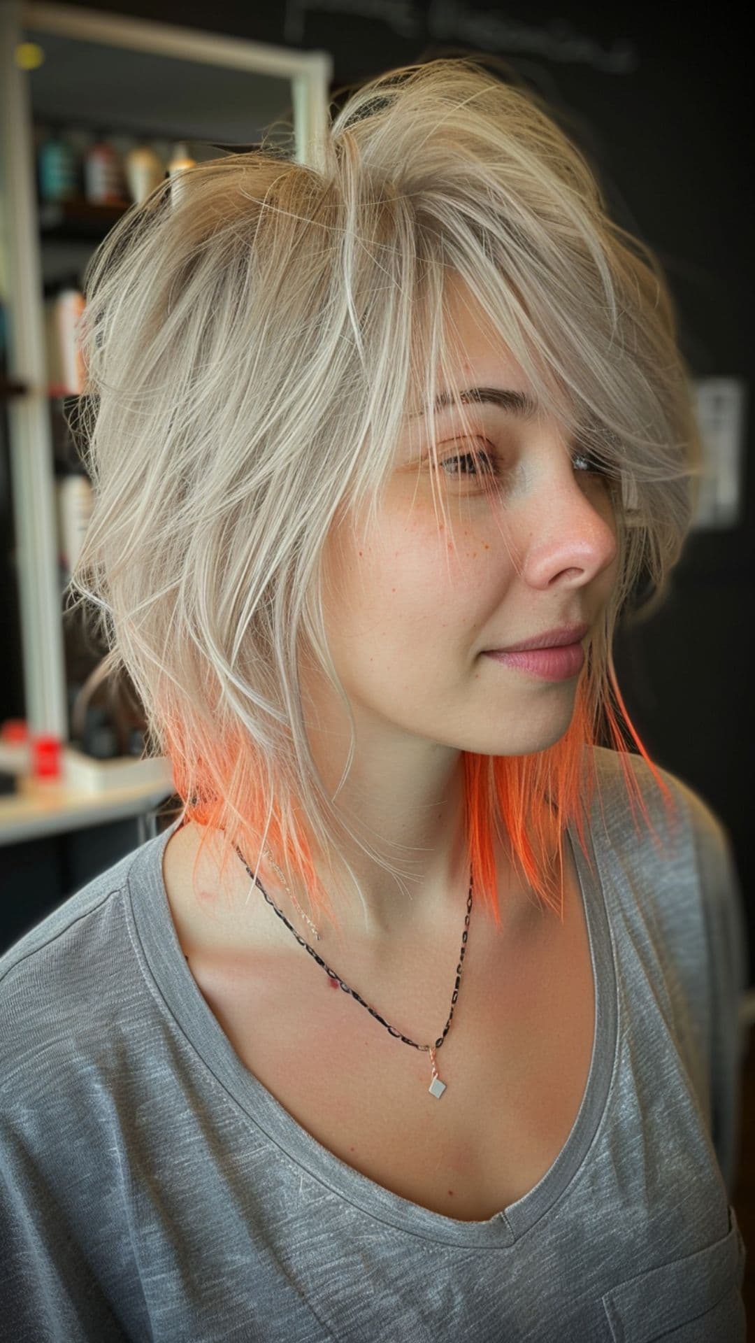 A woman modelling a silver hair with peach tips.