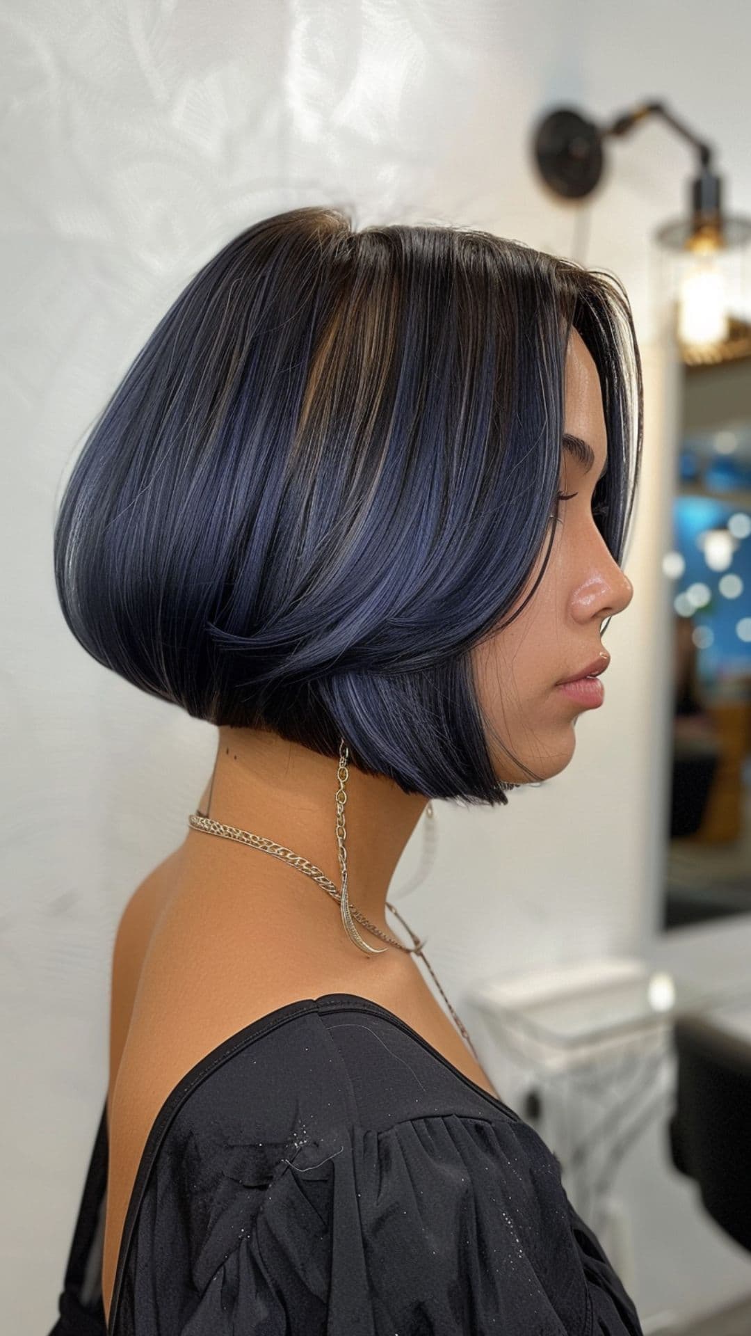 A woman modelling a sleek inverted bob.