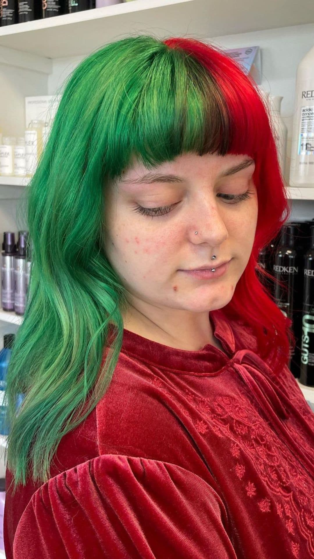 A woman modelling a Split Dye Red and Green with Blunt Bangs hairstyle.